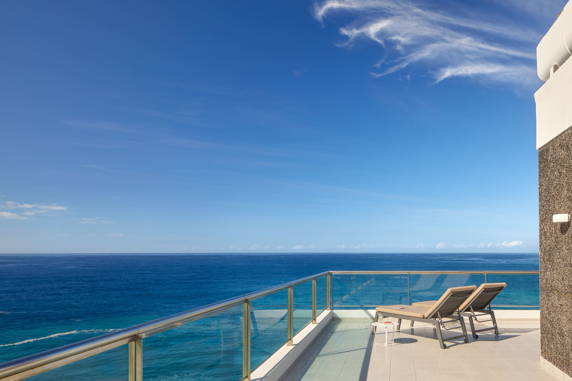 chairs on a deck overlooking the ocean