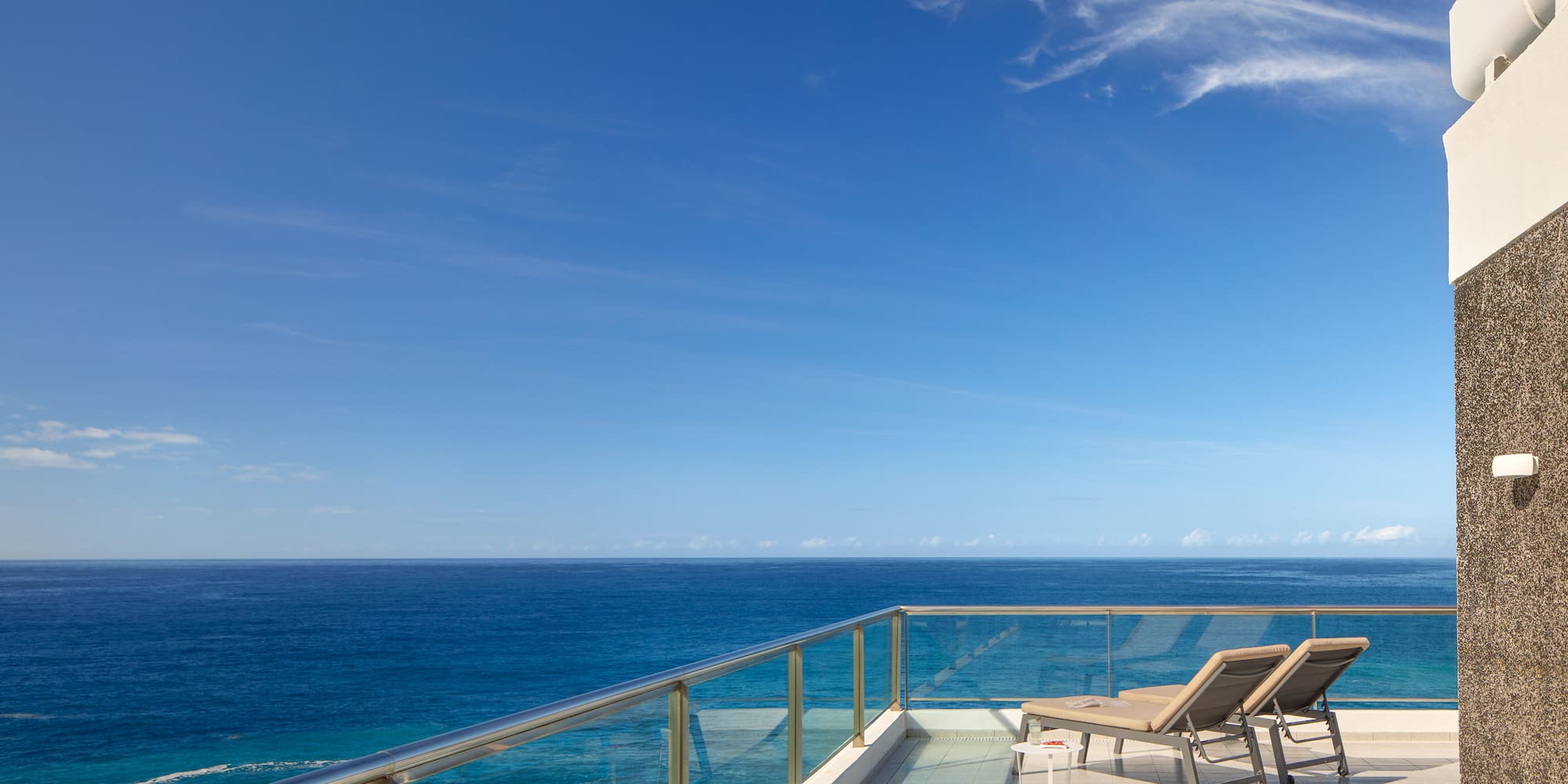 chairs on a deck overlooking the ocean
