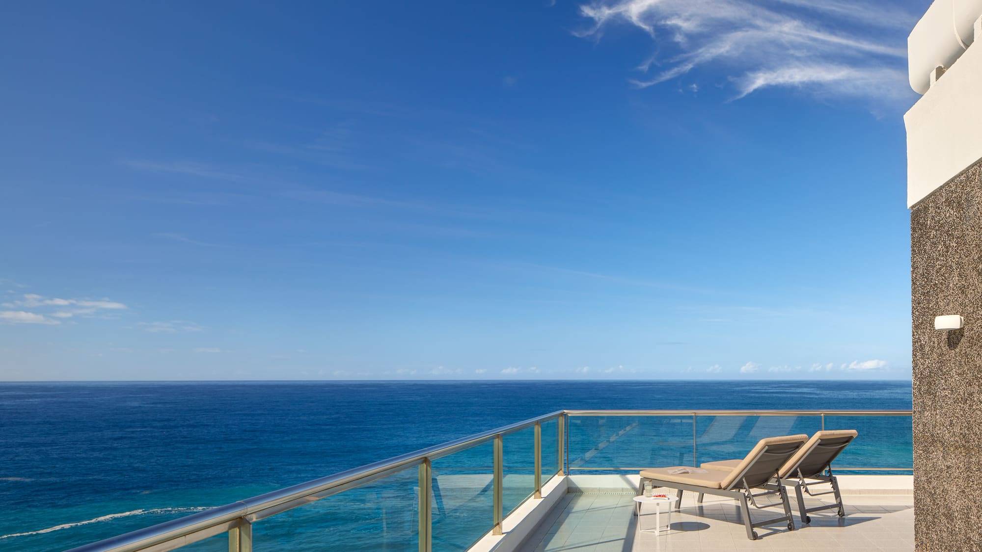 chairs on a deck overlooking the ocean
