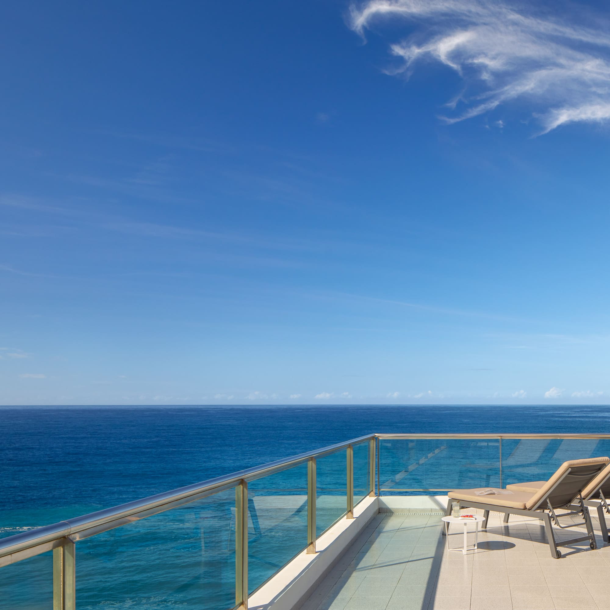 chairs on a deck overlooking the ocean