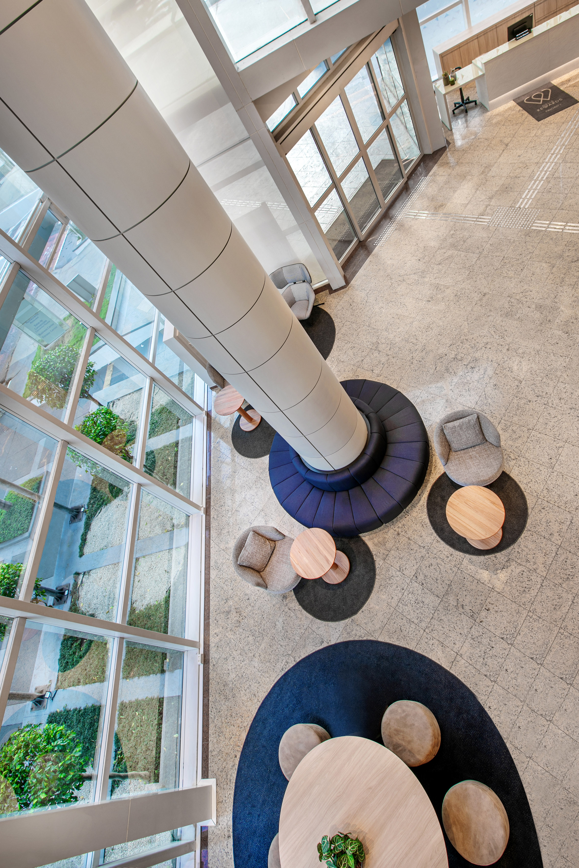 a room with a tall column and chairs