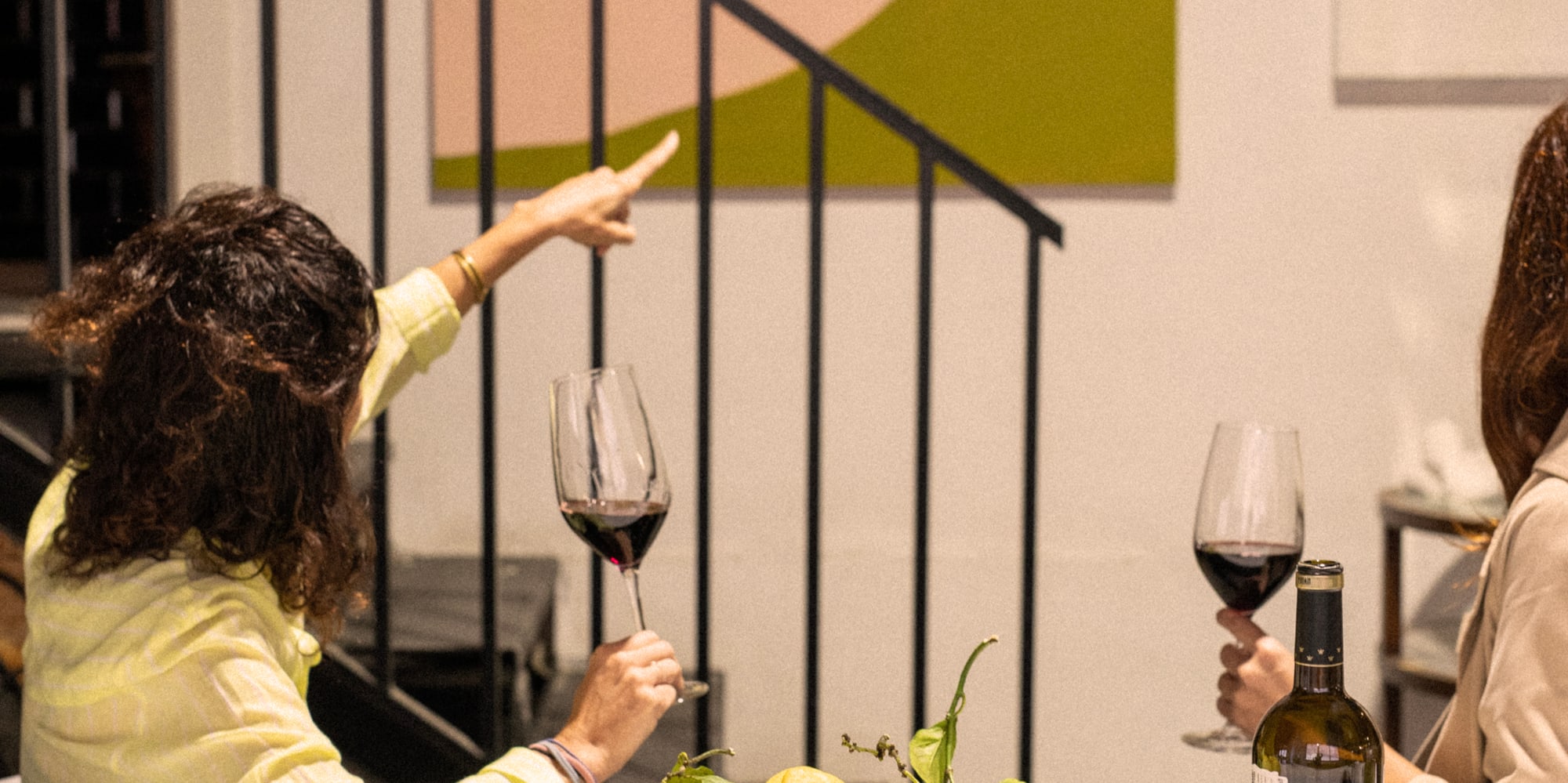 a group of women sitting at a table with wine glasses