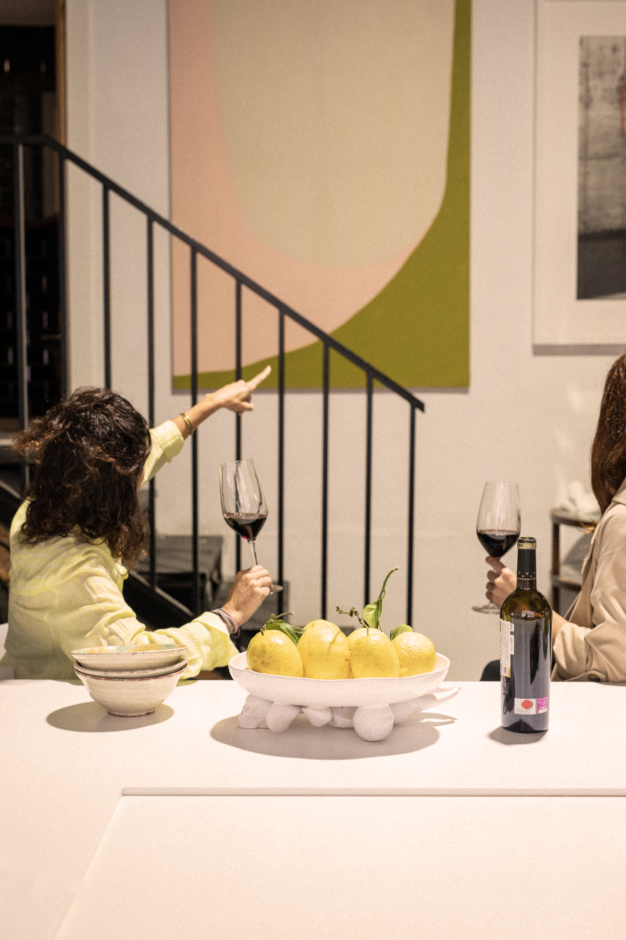 a group of women sitting at a table with wine glasses