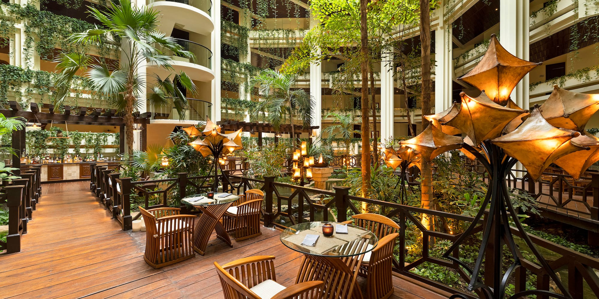 a patio with tables and chairs and trees
