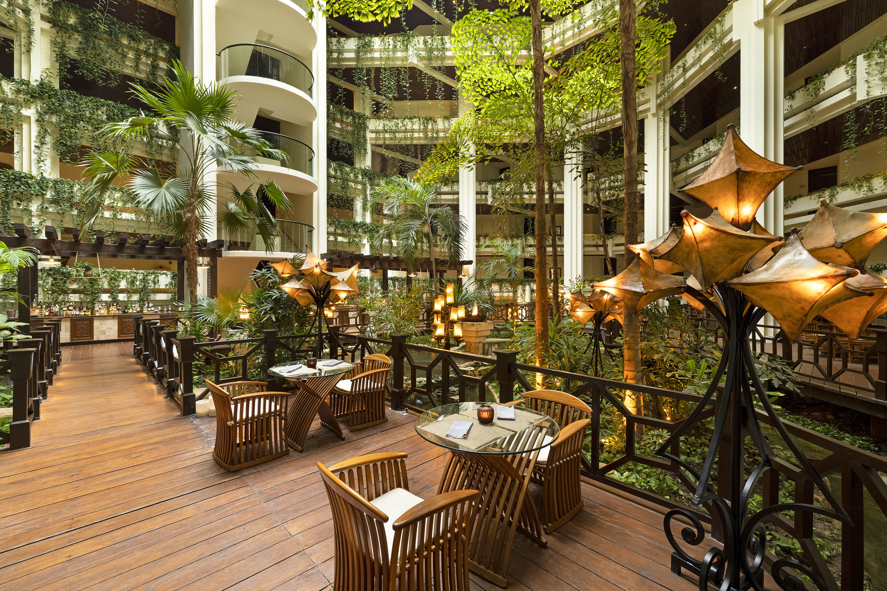 a patio with tables and chairs and trees