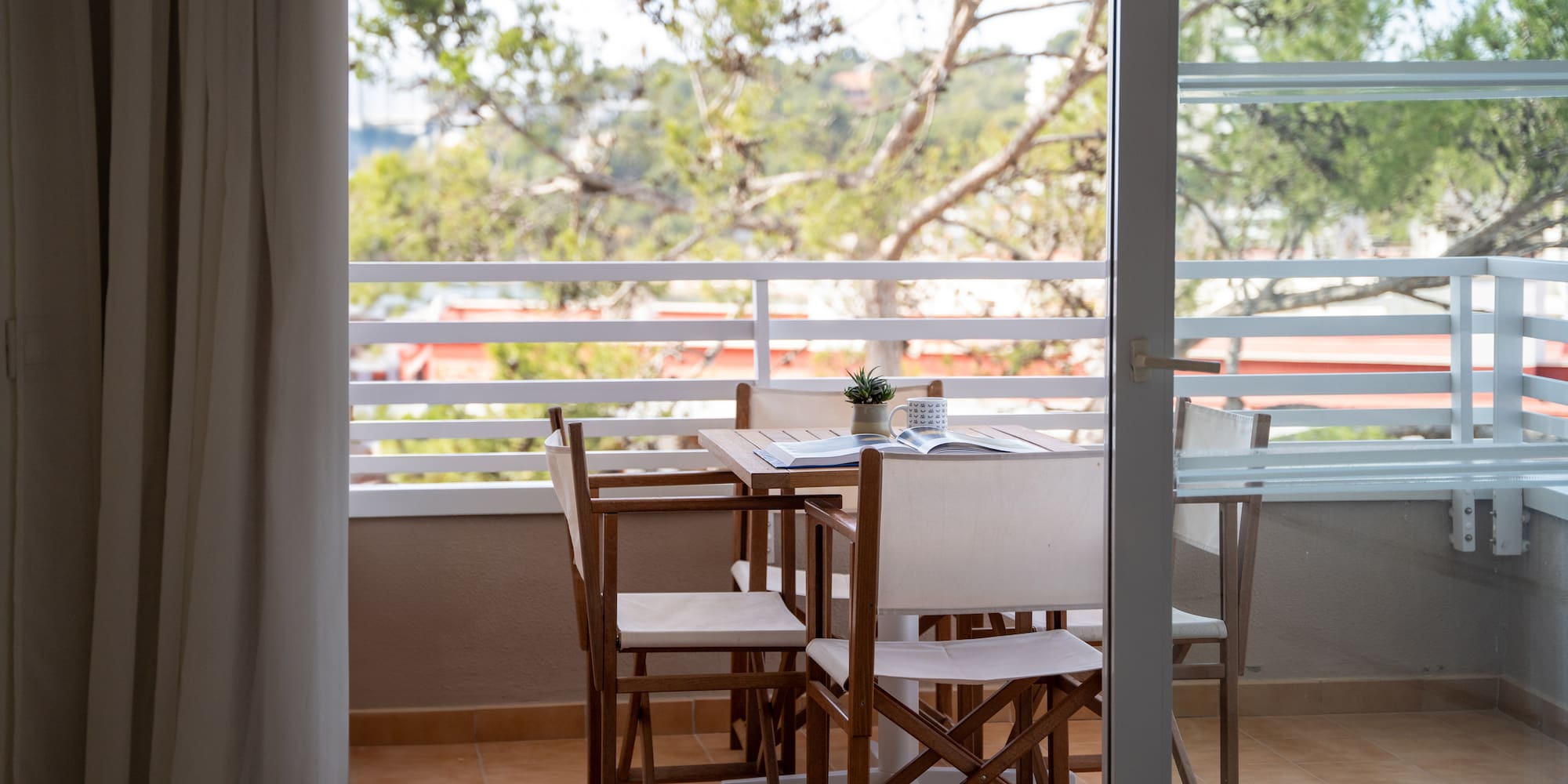 a table and chairs on a balcony