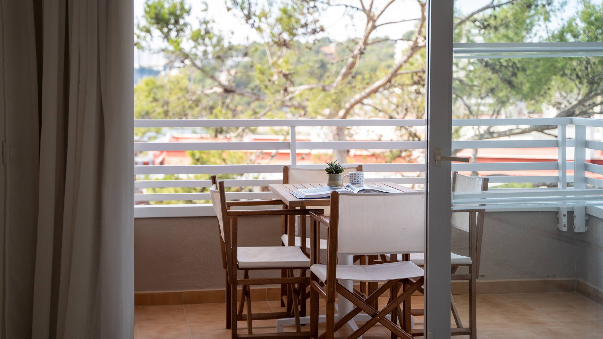 a table and chairs on a balcony