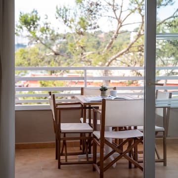 a table and chairs on a balcony