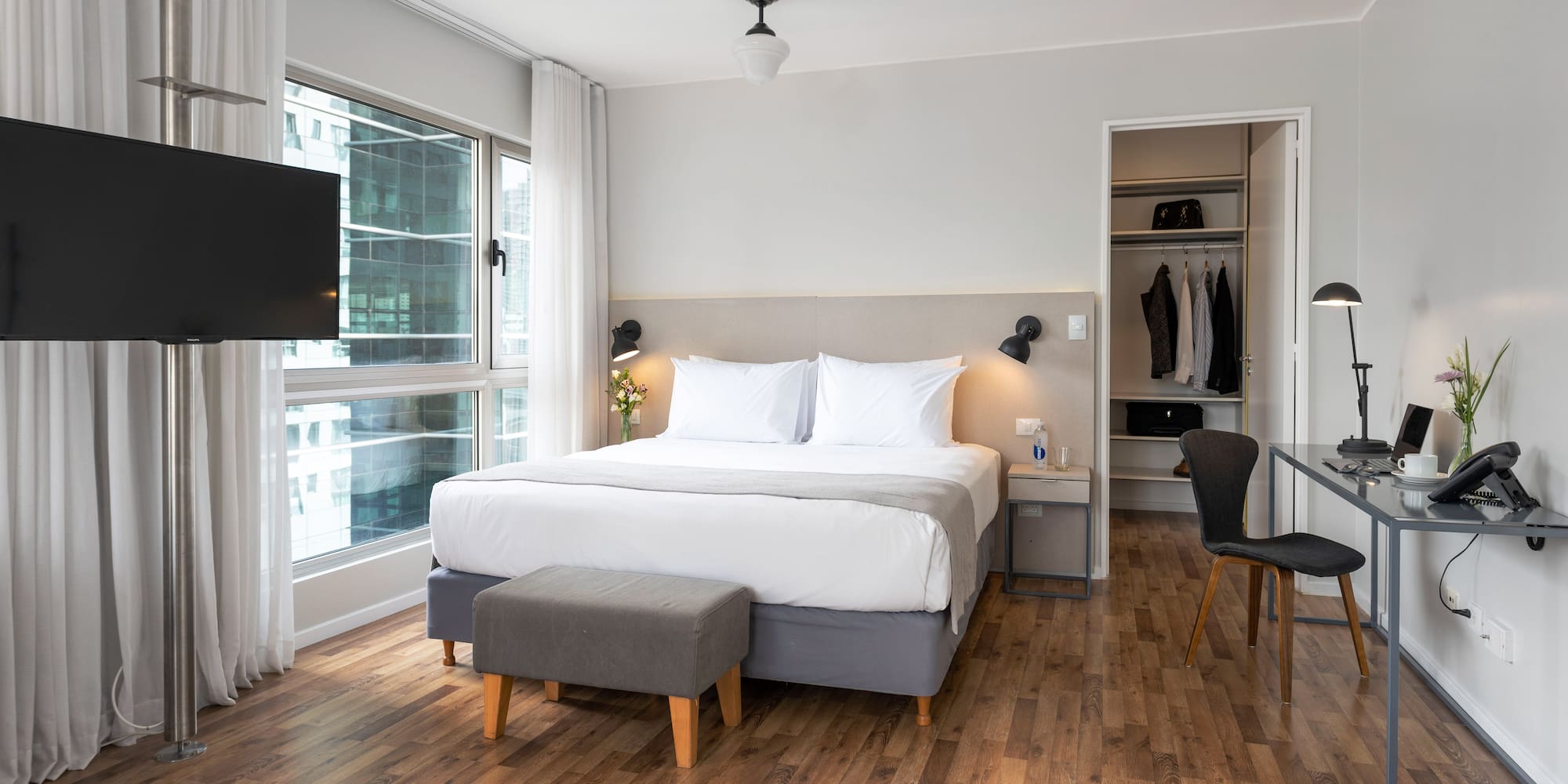 a bedroom with a bed and a tv