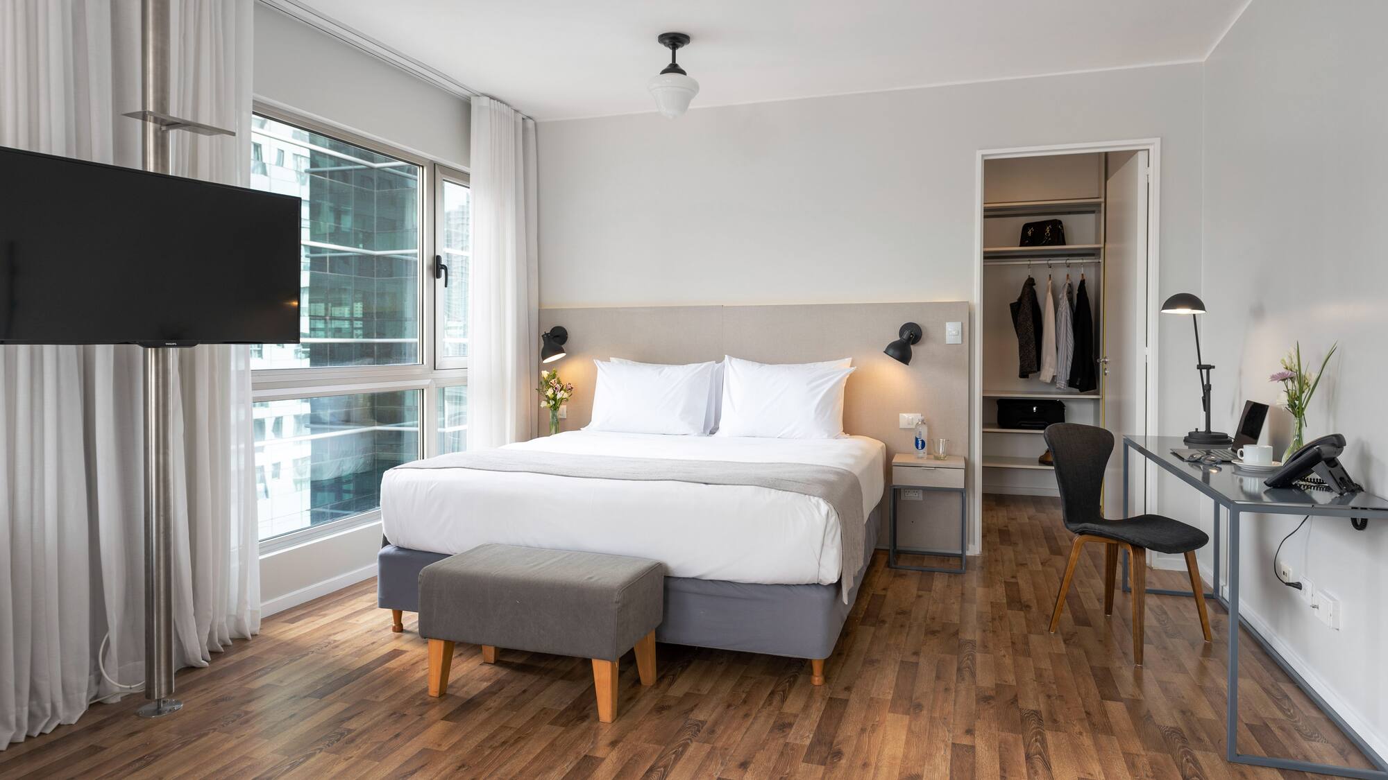 a bedroom with a bed and a tv