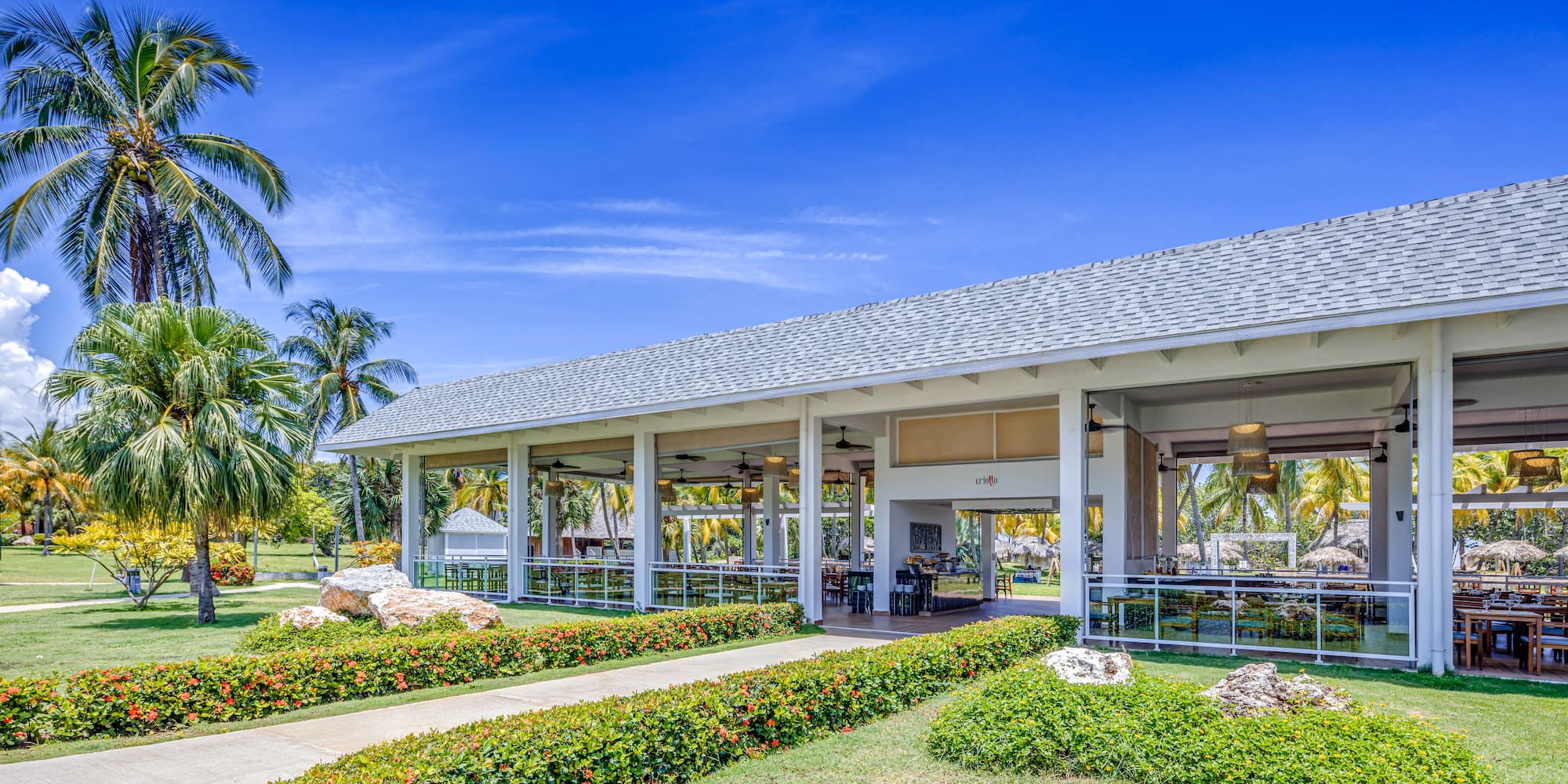 a building with a large roof and a walkway