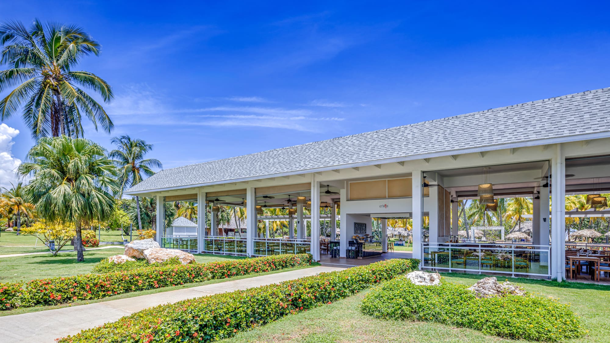 a building with a large roof and a walkway