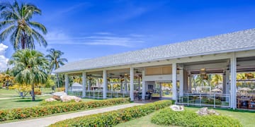 a building with a large roof and a walkway