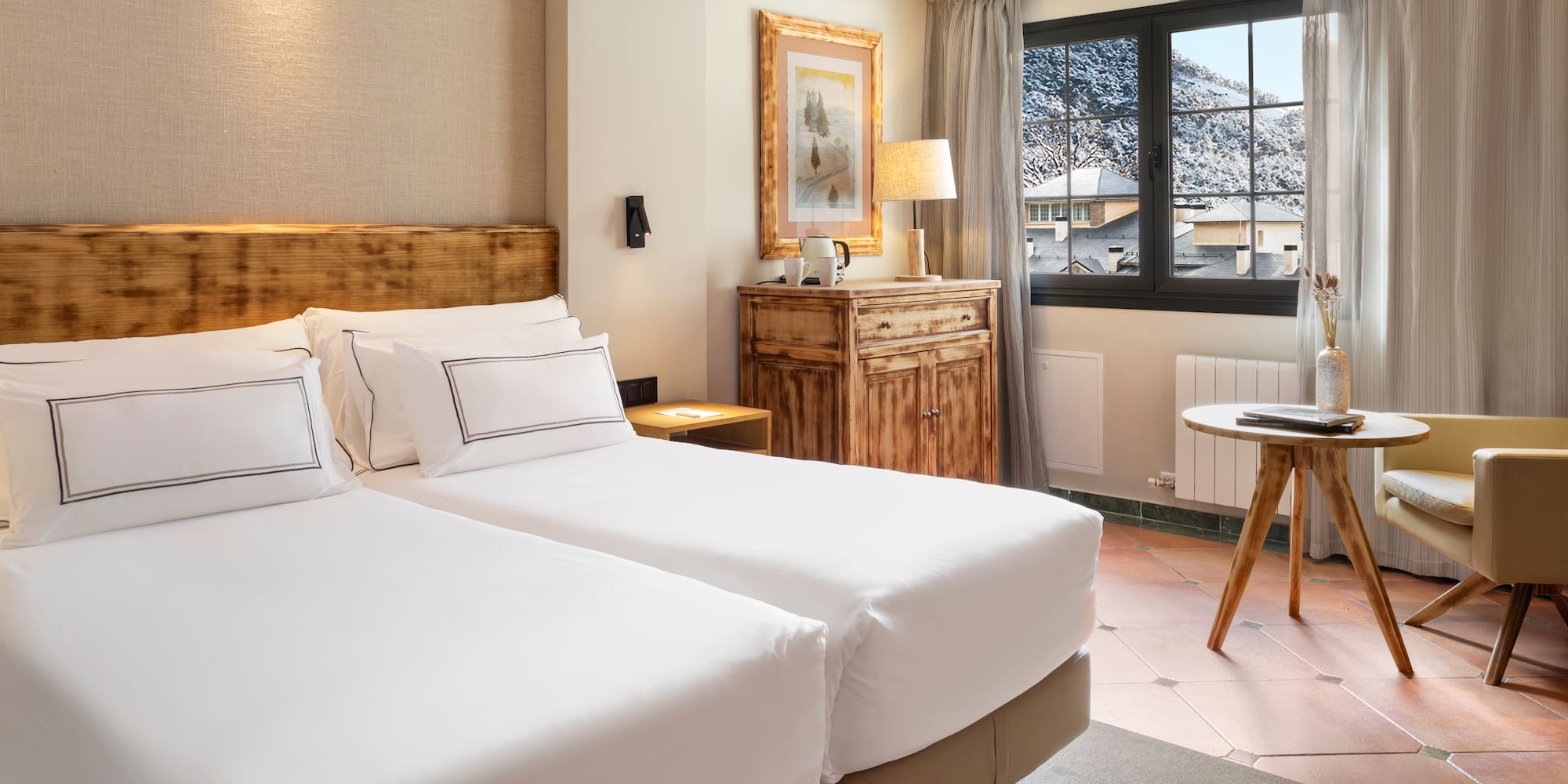 a room with two beds and a table