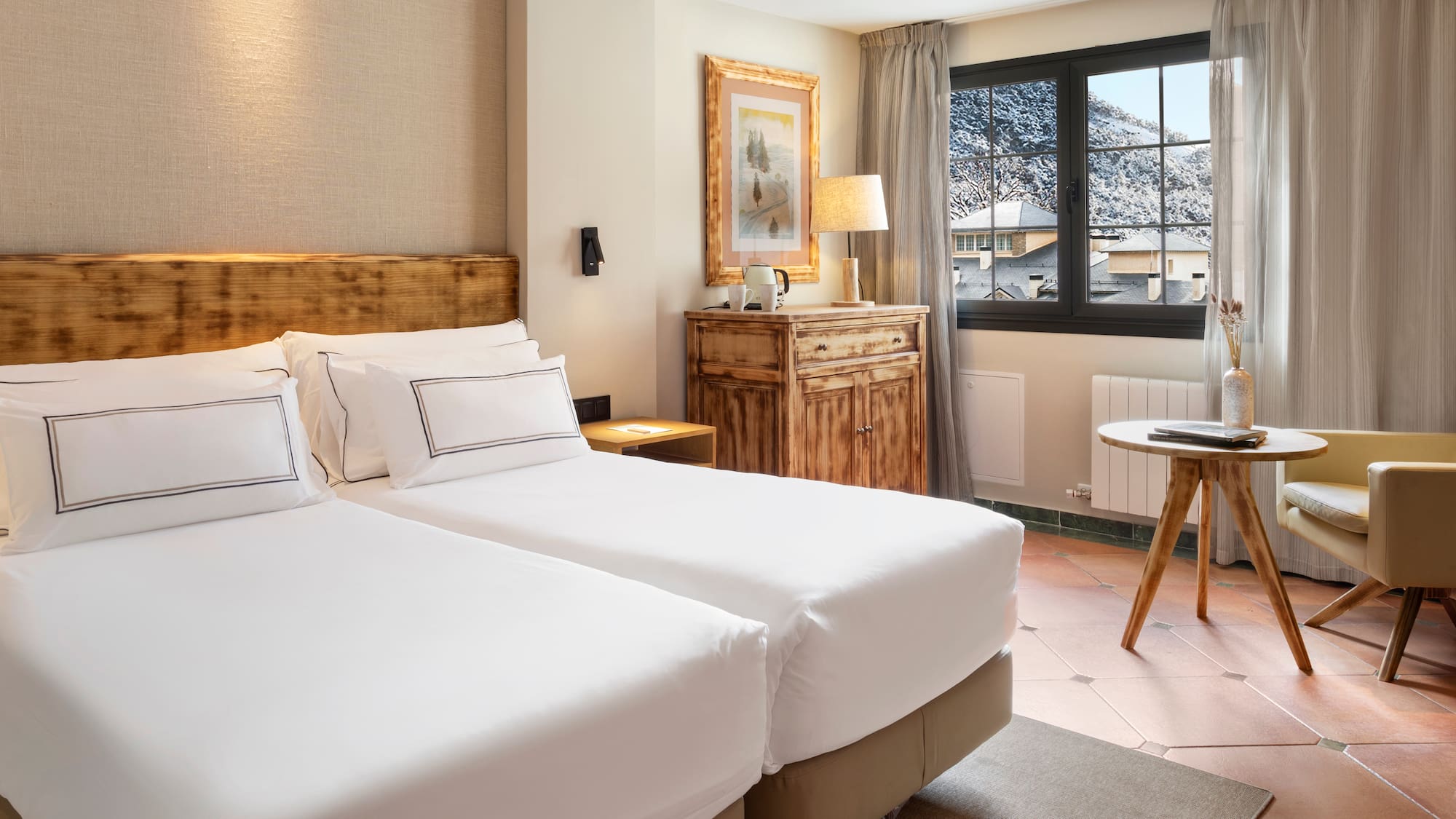 a room with two beds and a table