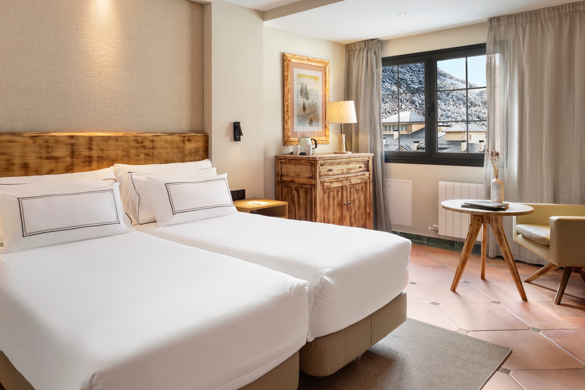 a room with two beds and a table