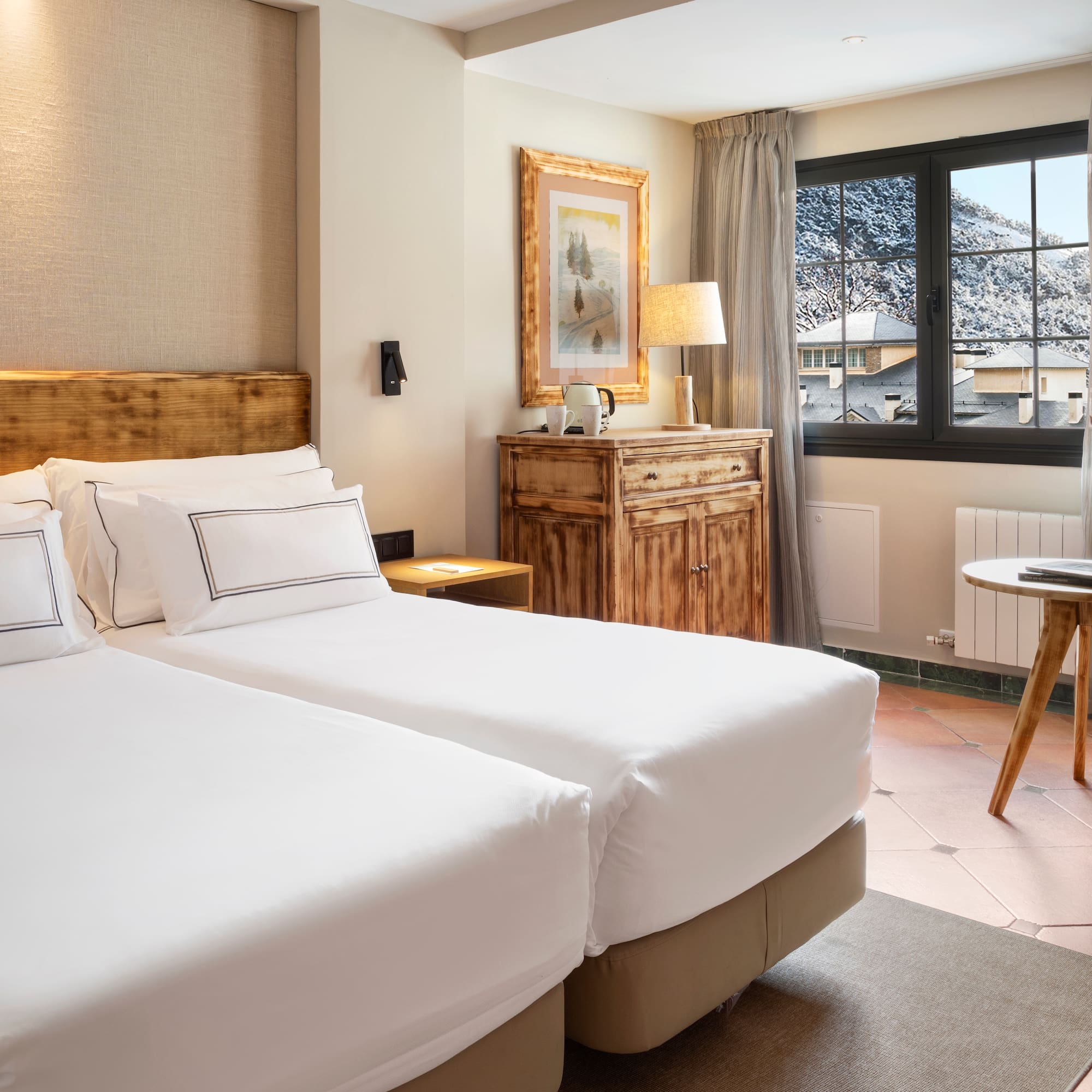 a room with two beds and a table