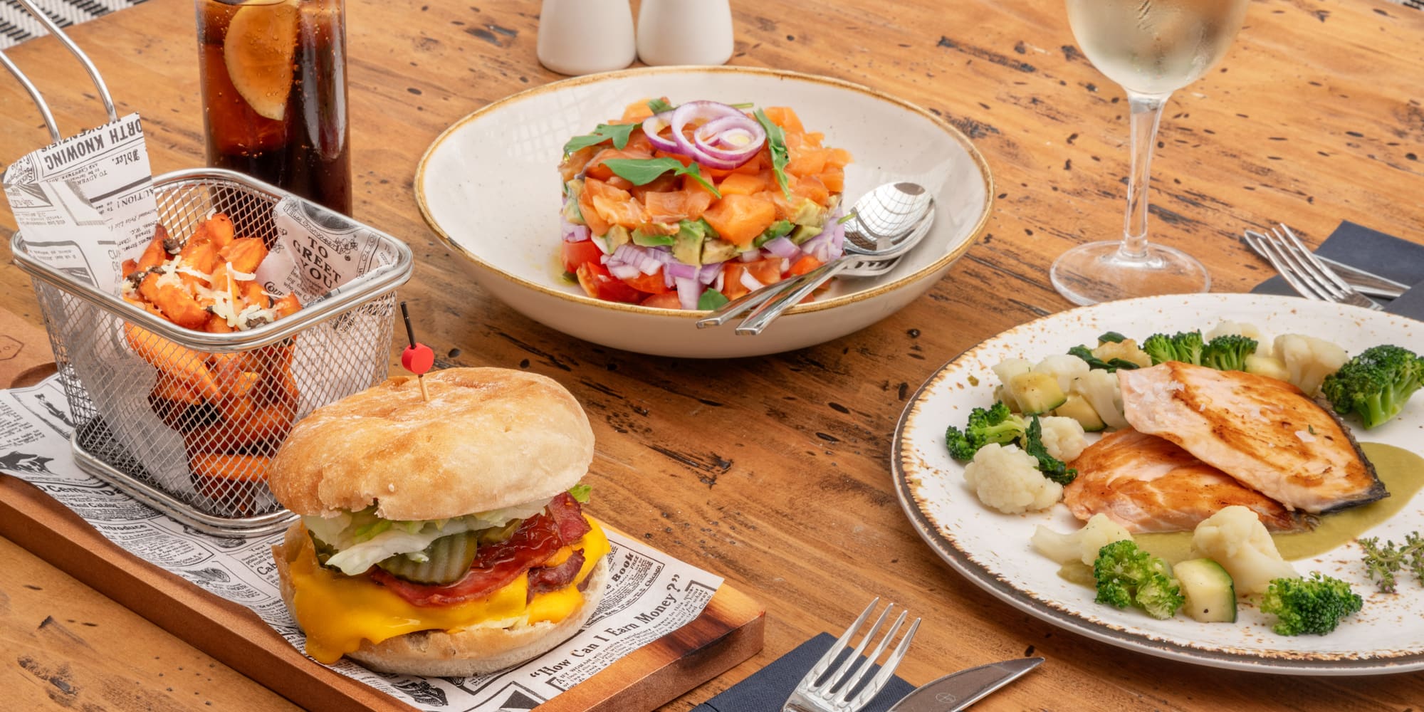a table with plates of food and a drink