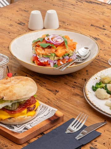 a table with plates of food and a drink