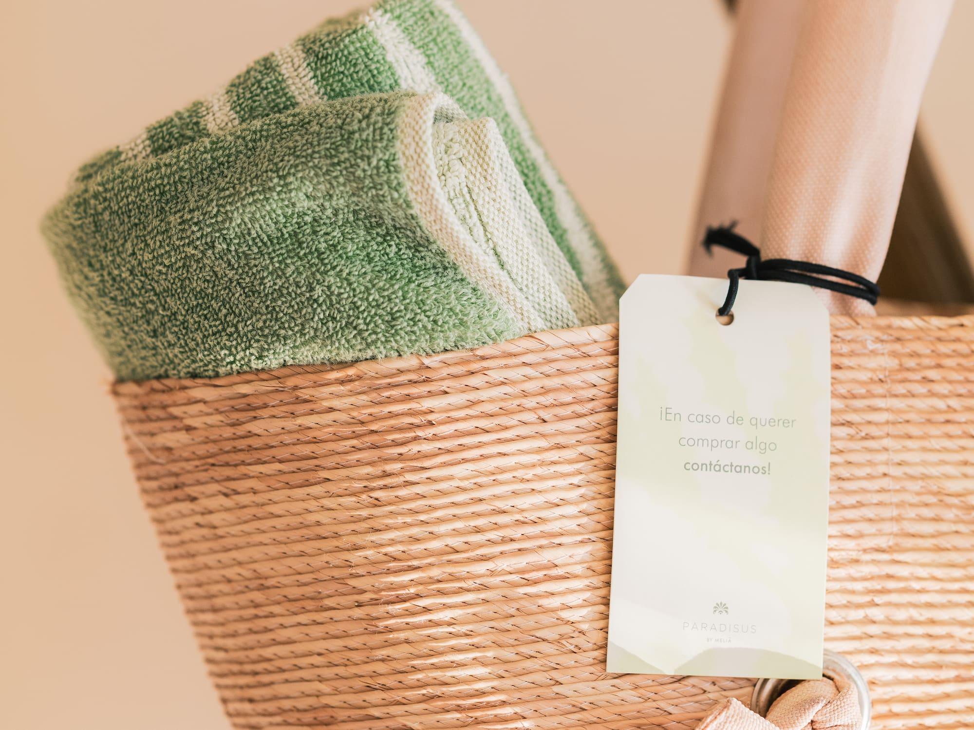 a basket with a towel and a tag