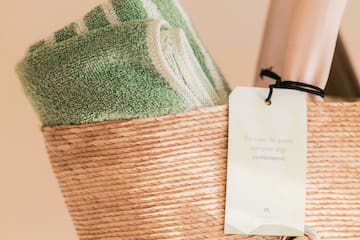 a basket with a towel and a tag