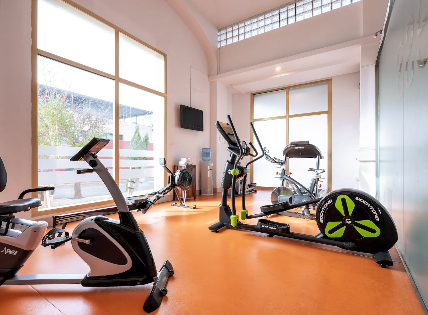a room with exercise bikes and a window