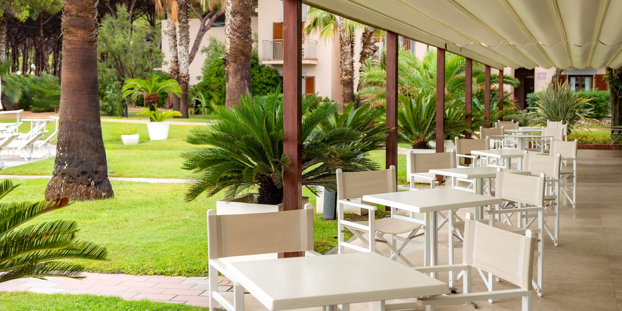 a white tables and chairs on a patio