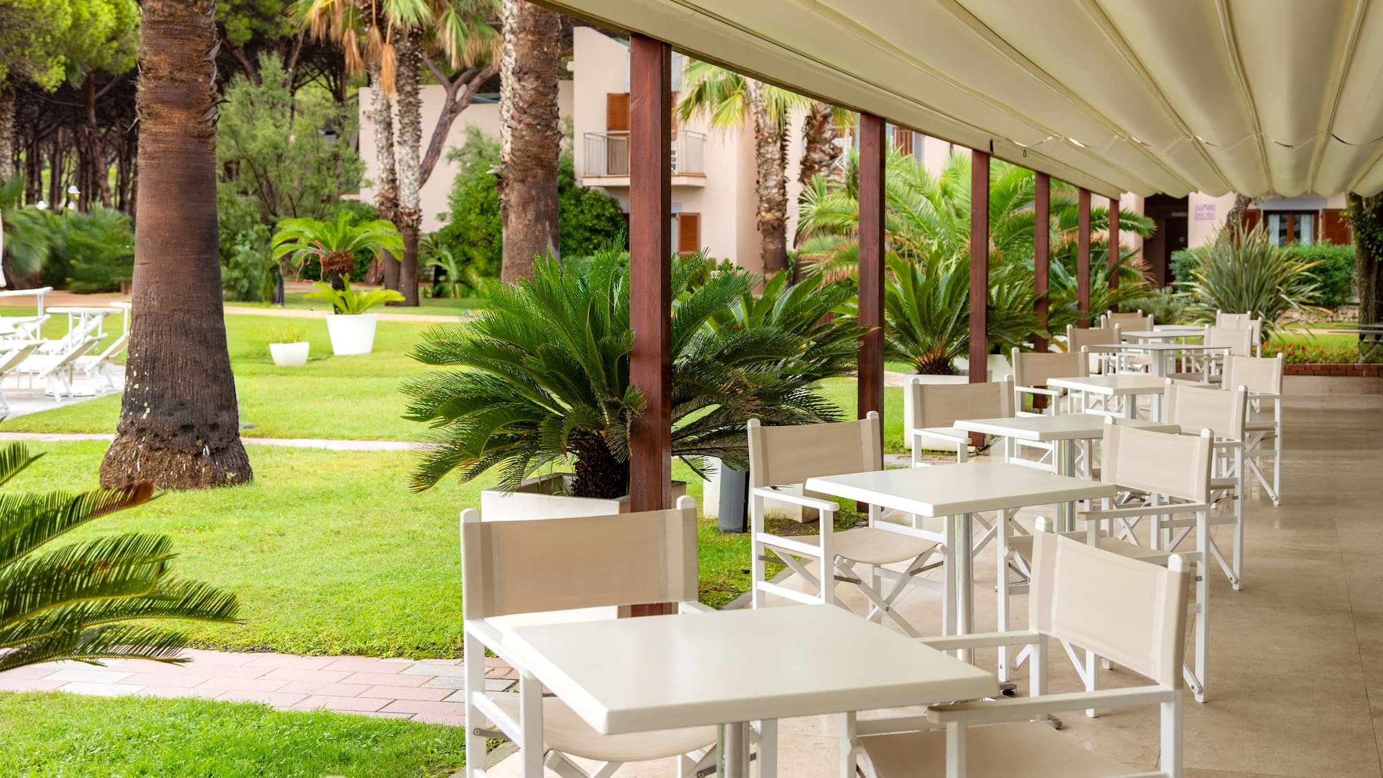 a white tables and chairs on a patio