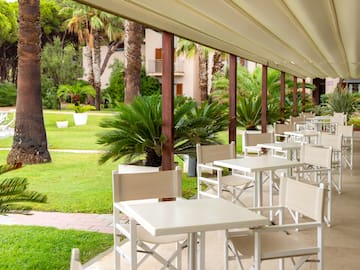 a white tables and chairs on a patio