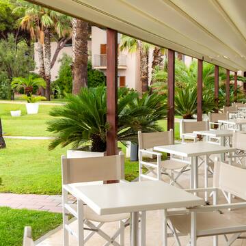 a white tables and chairs on a patio