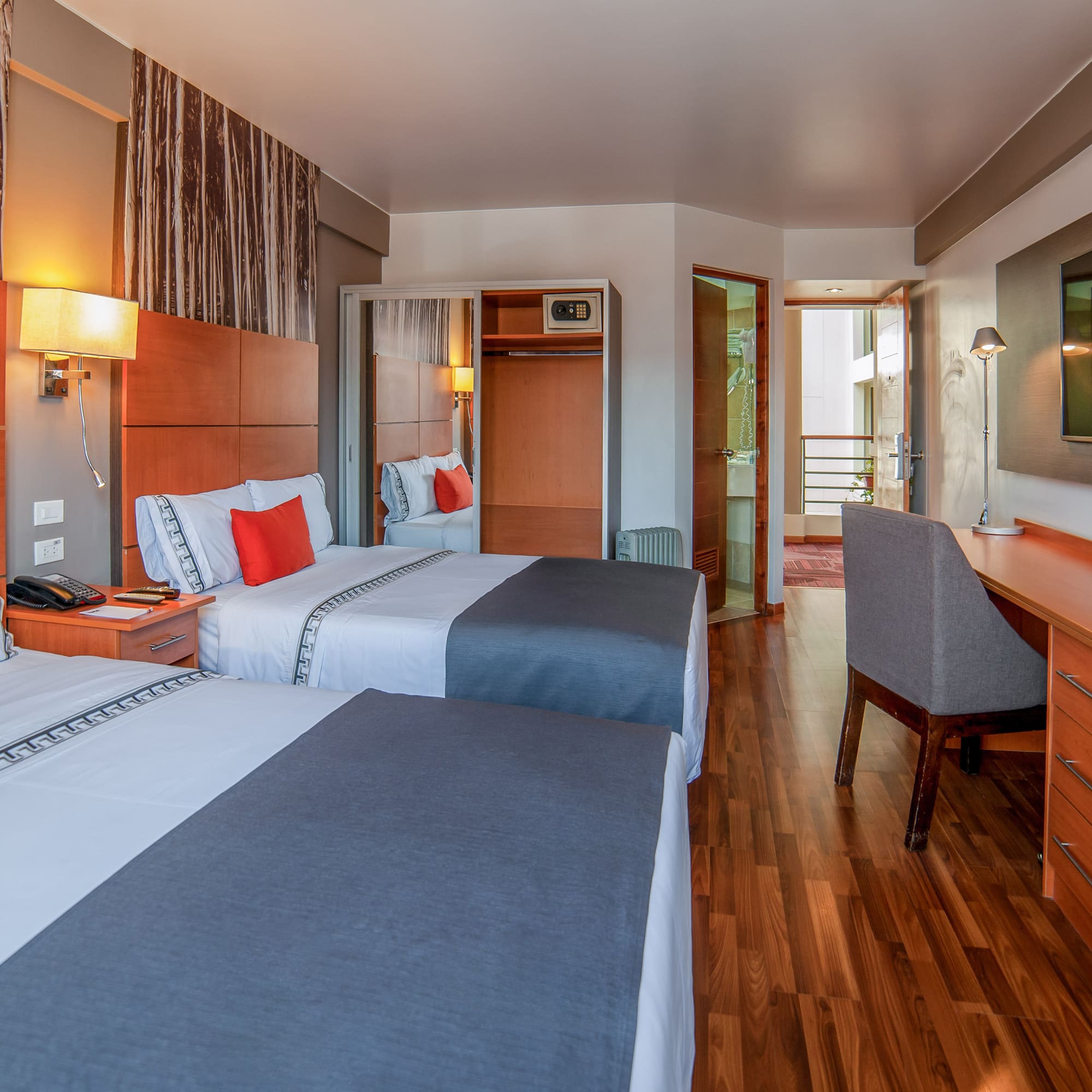 a room with two beds and a desk