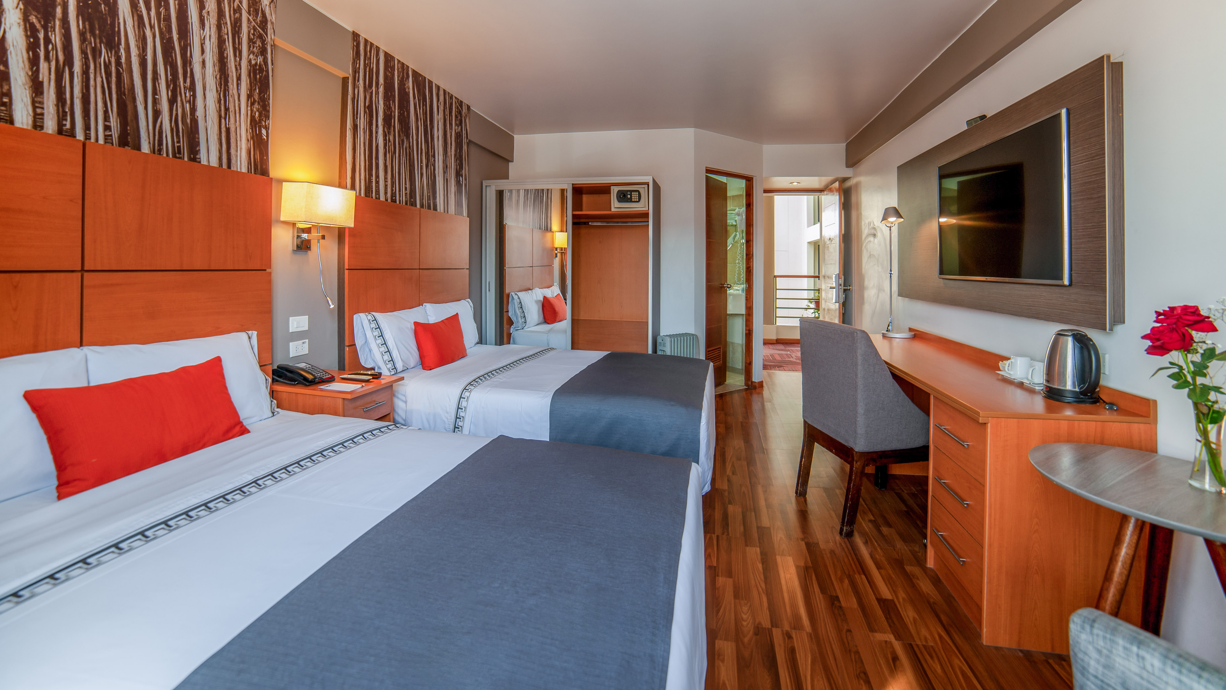 a room with two beds and a desk