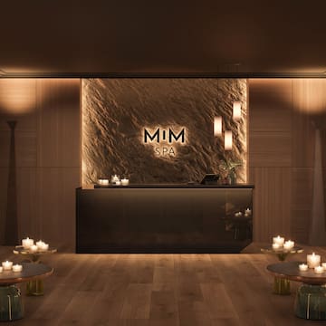 a reception area with candles on the wall