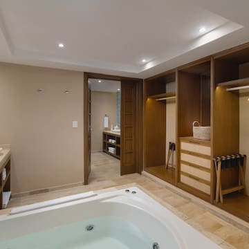 a bathroom with a tub and shelves