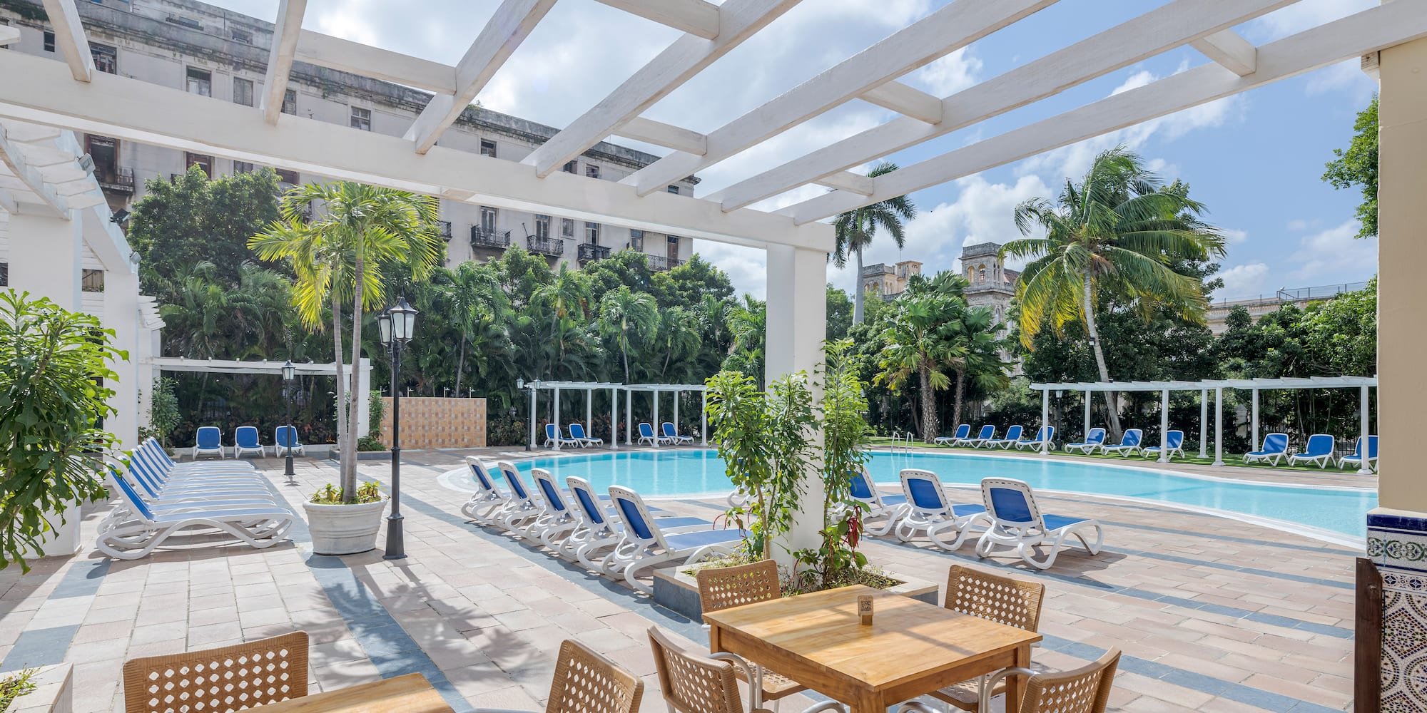 a pool with chairs and tables