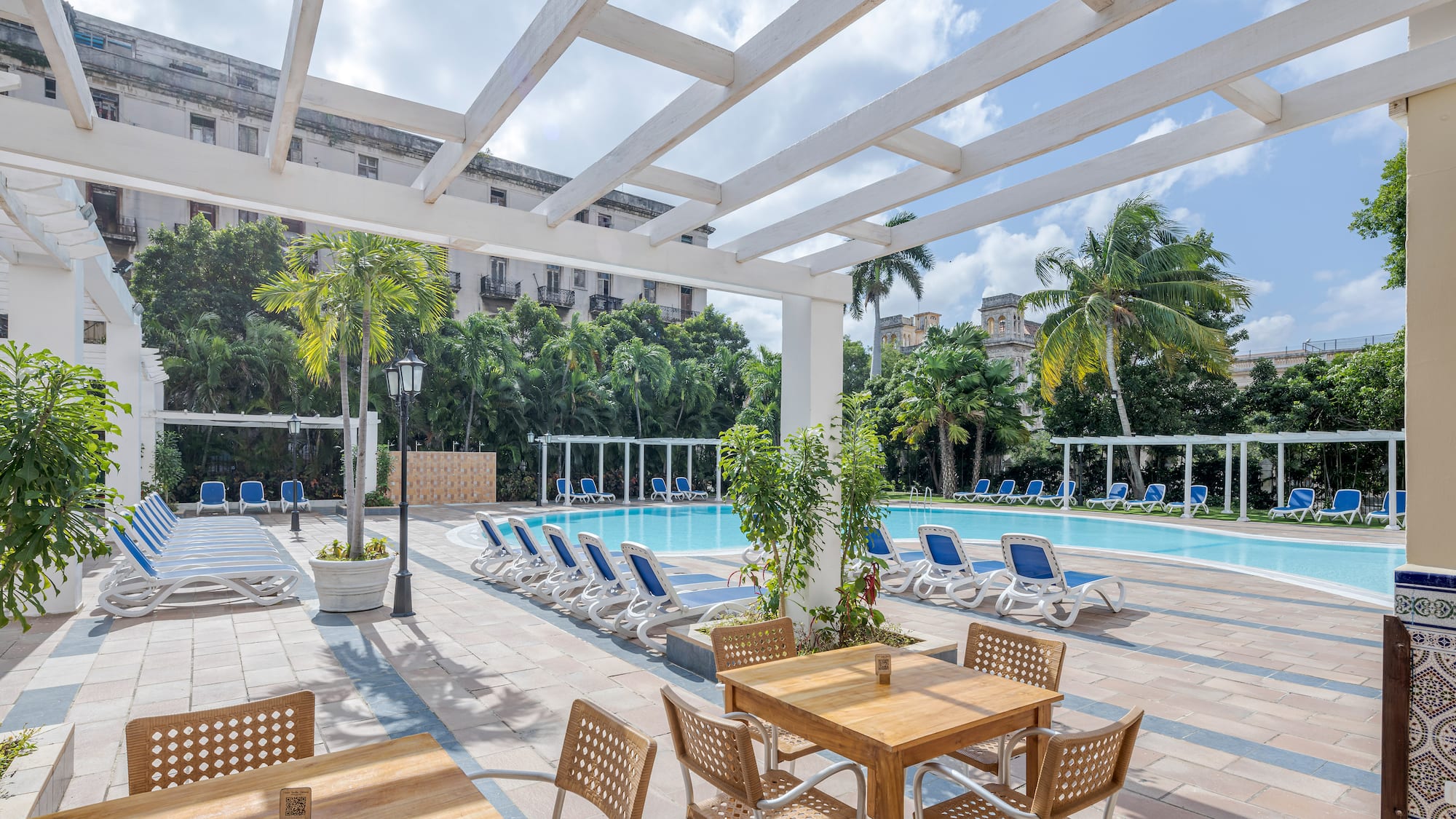 a pool with chairs and tables