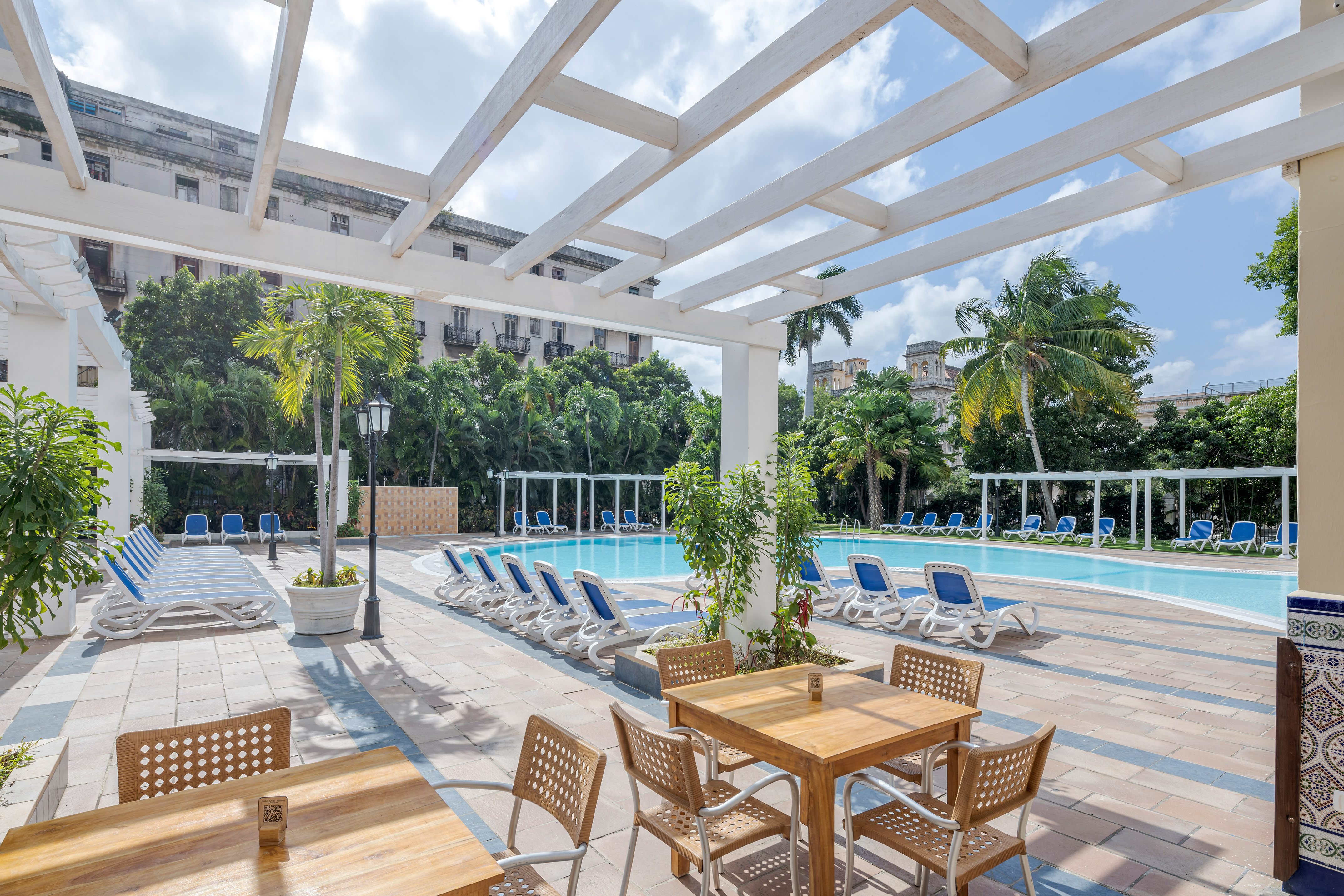 a pool with chairs and tables