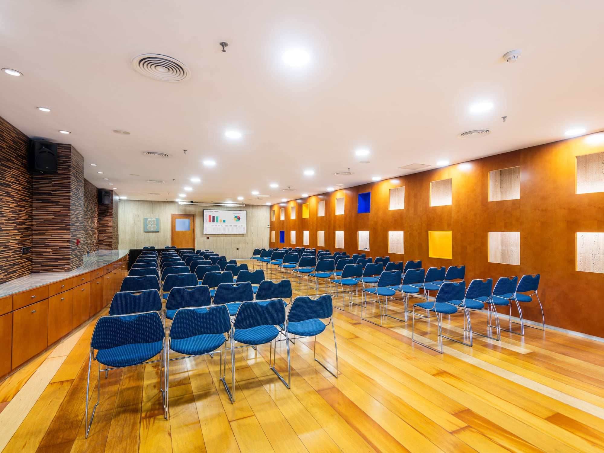 a room with blue chairs and a wood floor