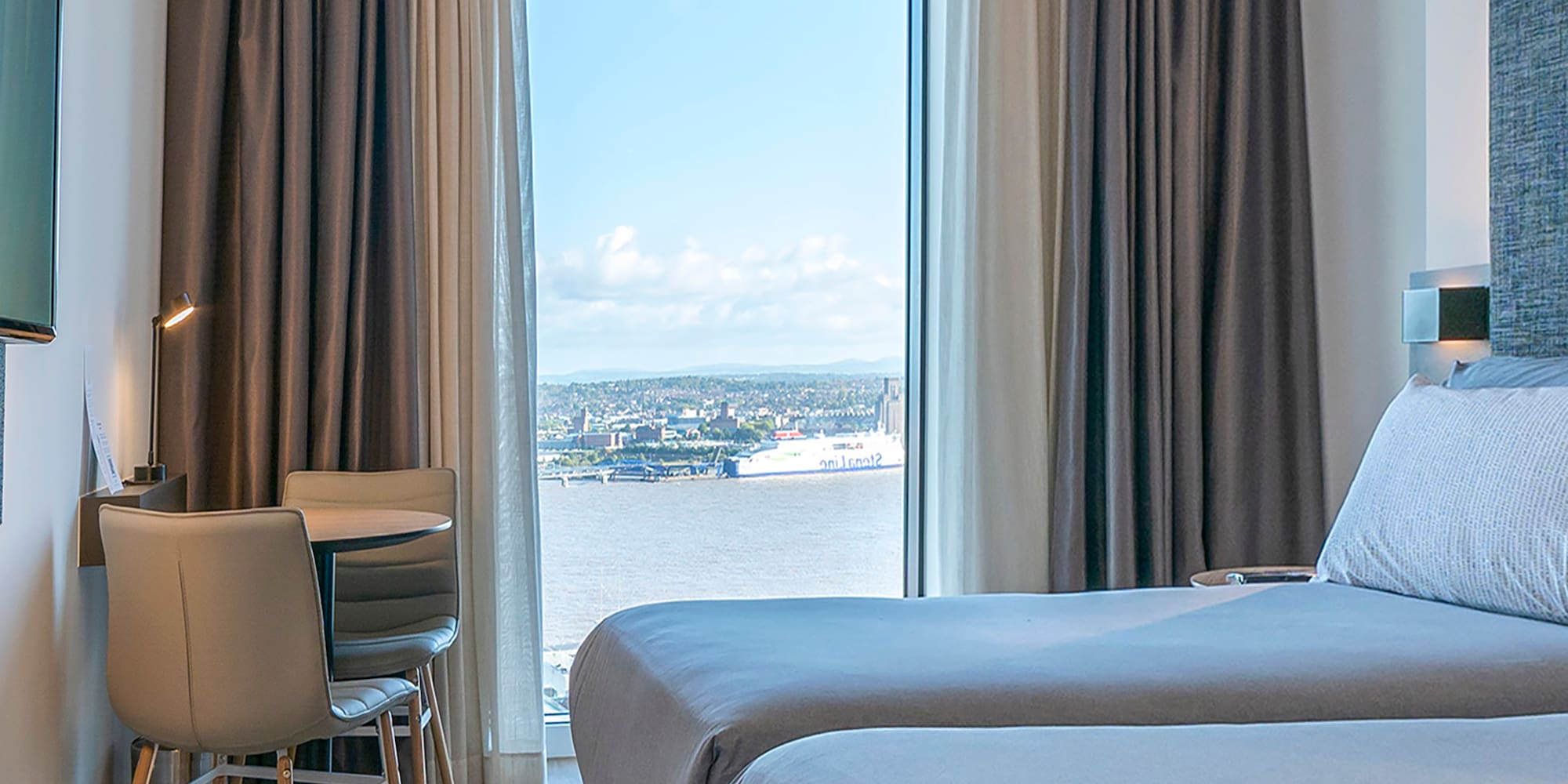 a room with two beds and a television