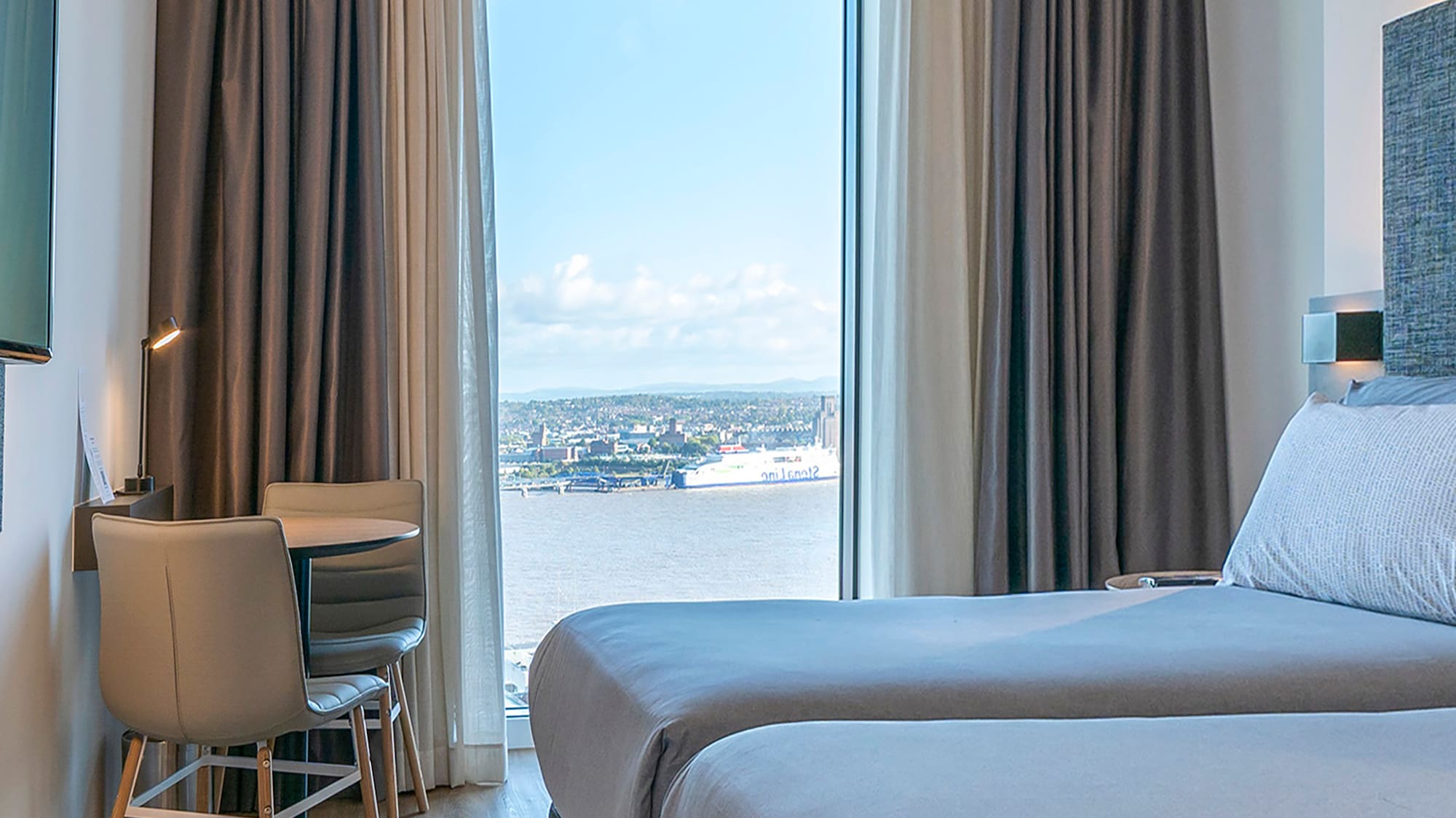 a room with two beds and a television