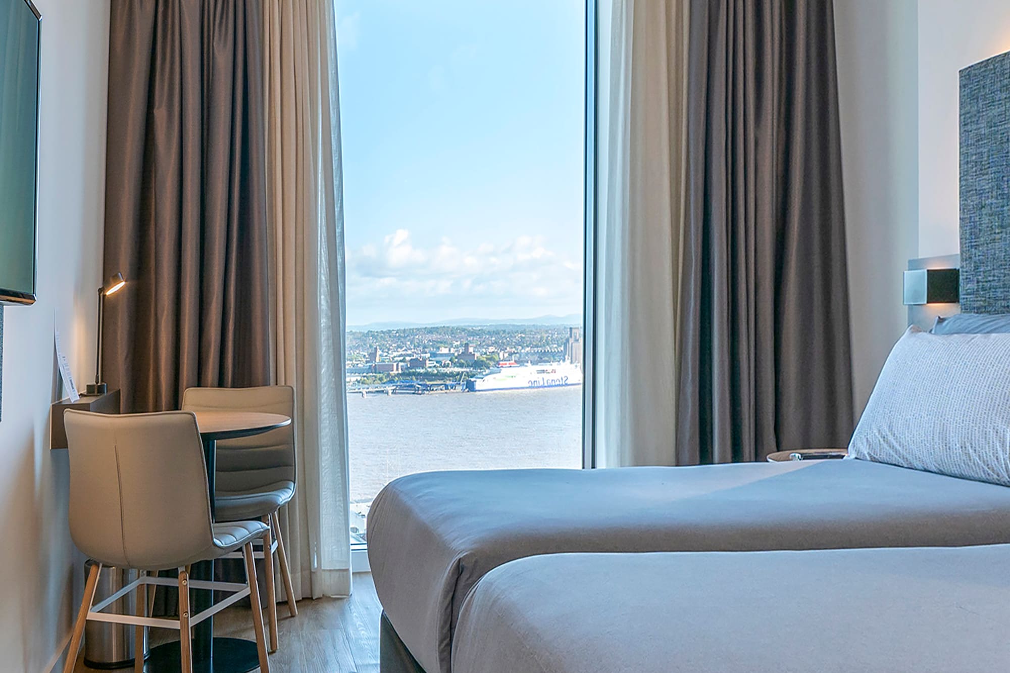 a room with two beds and a television