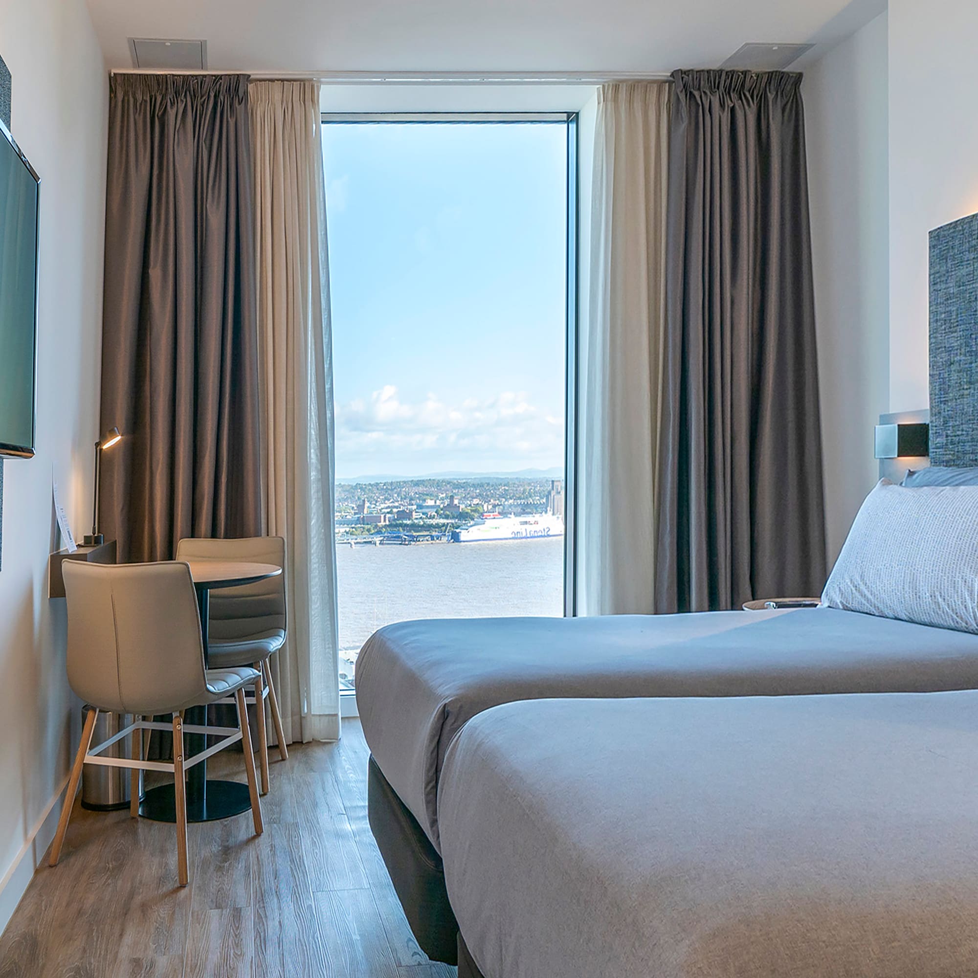 a room with two beds and a television