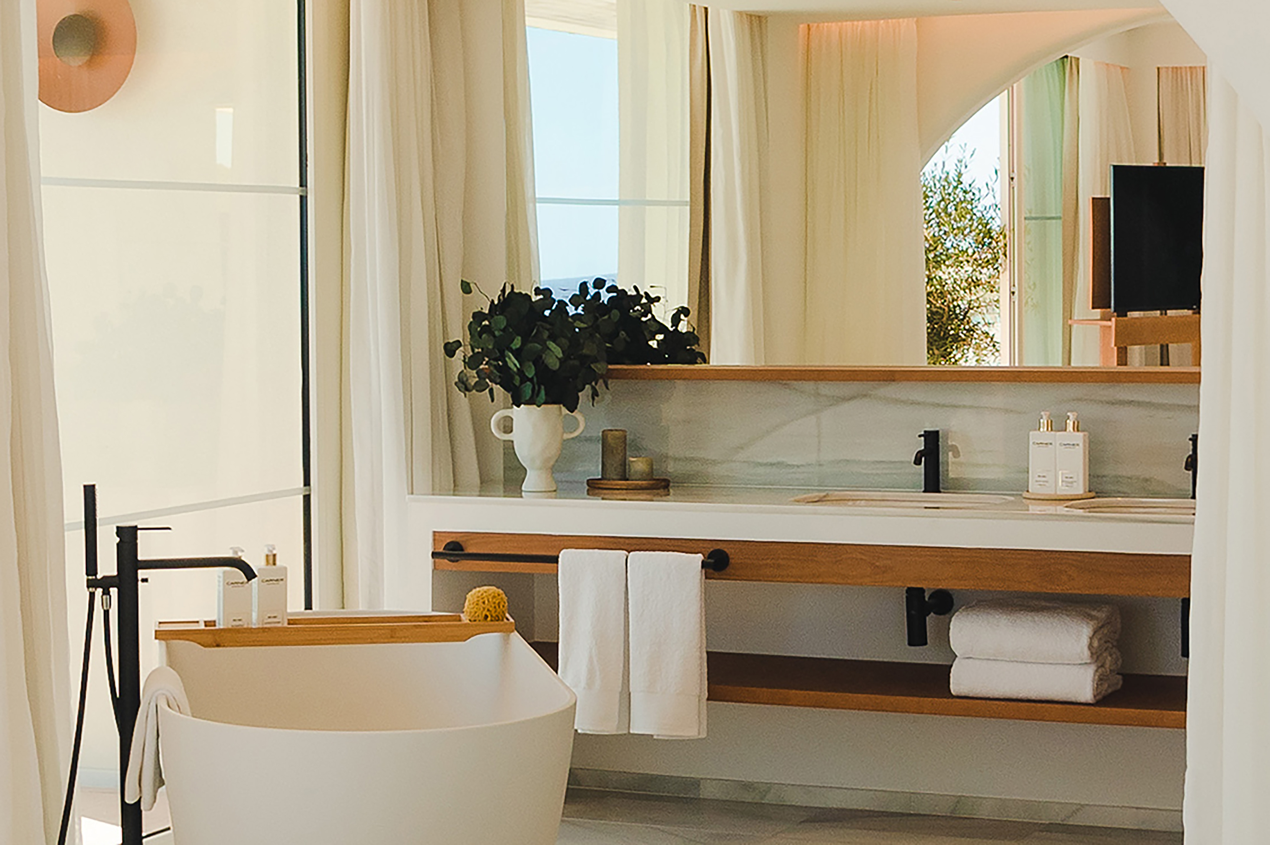 Modern luxury bathroom with freestanding tub and elegant double vanity.