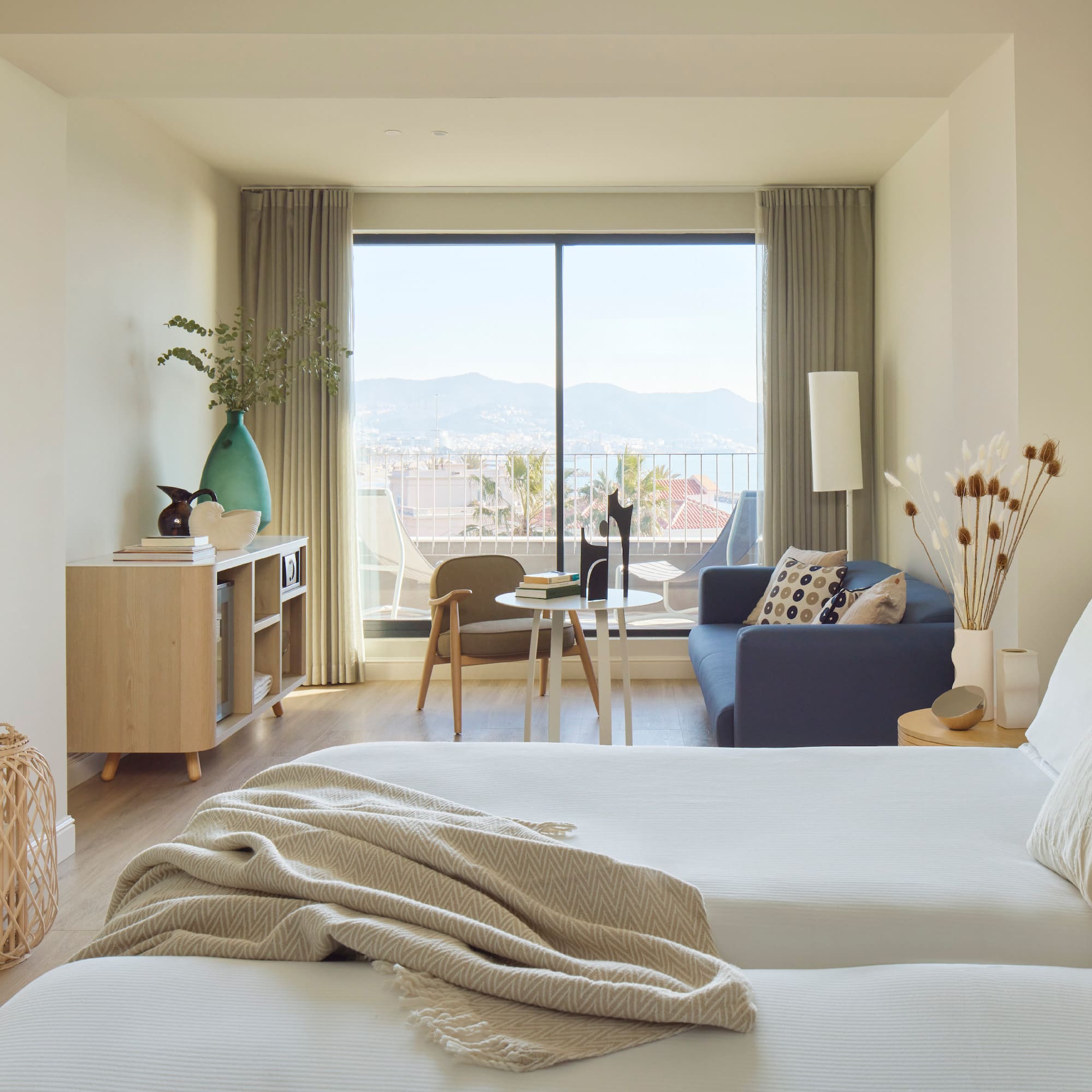 a bedroom with a window and a couch