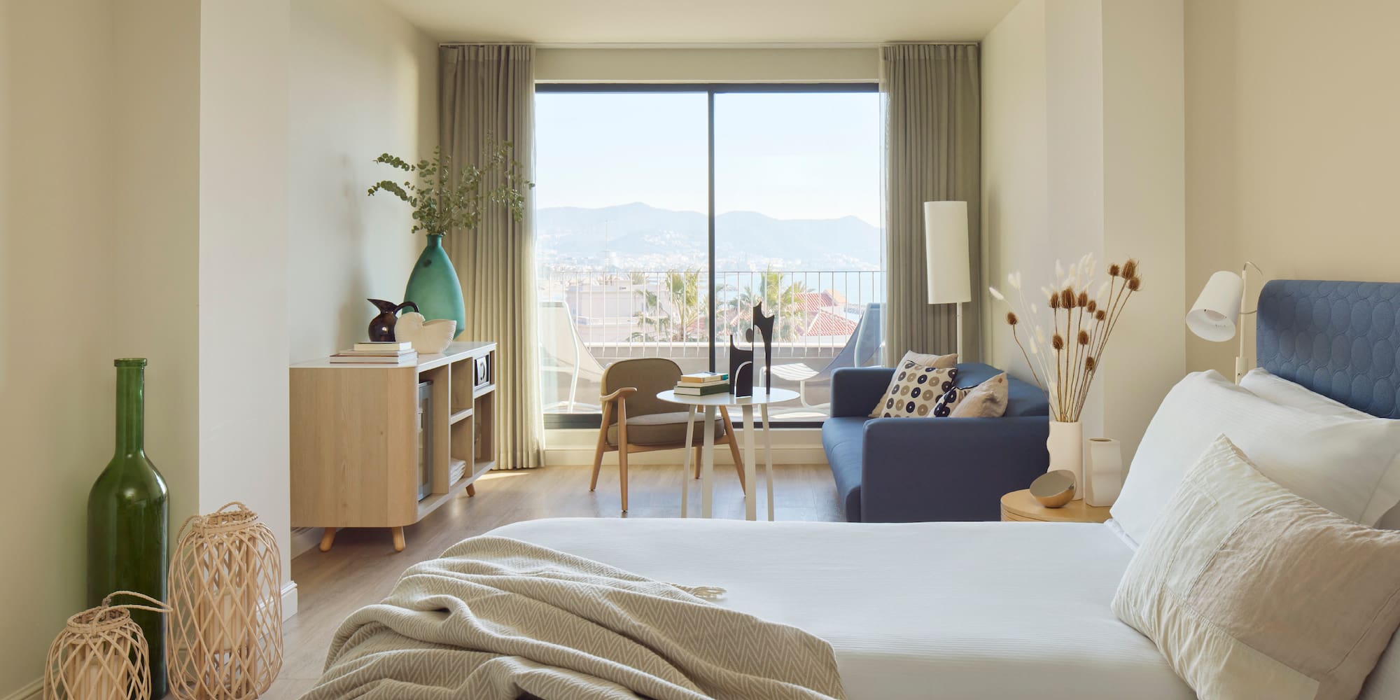 a bedroom with a window and a couch