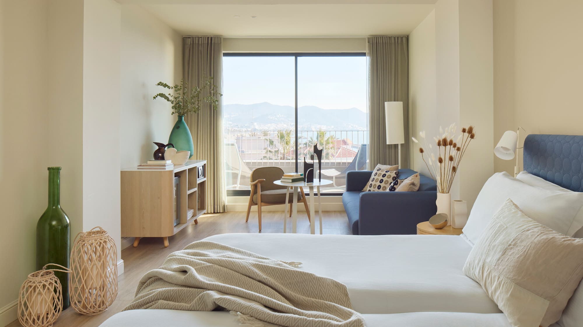 a bedroom with a window and a couch