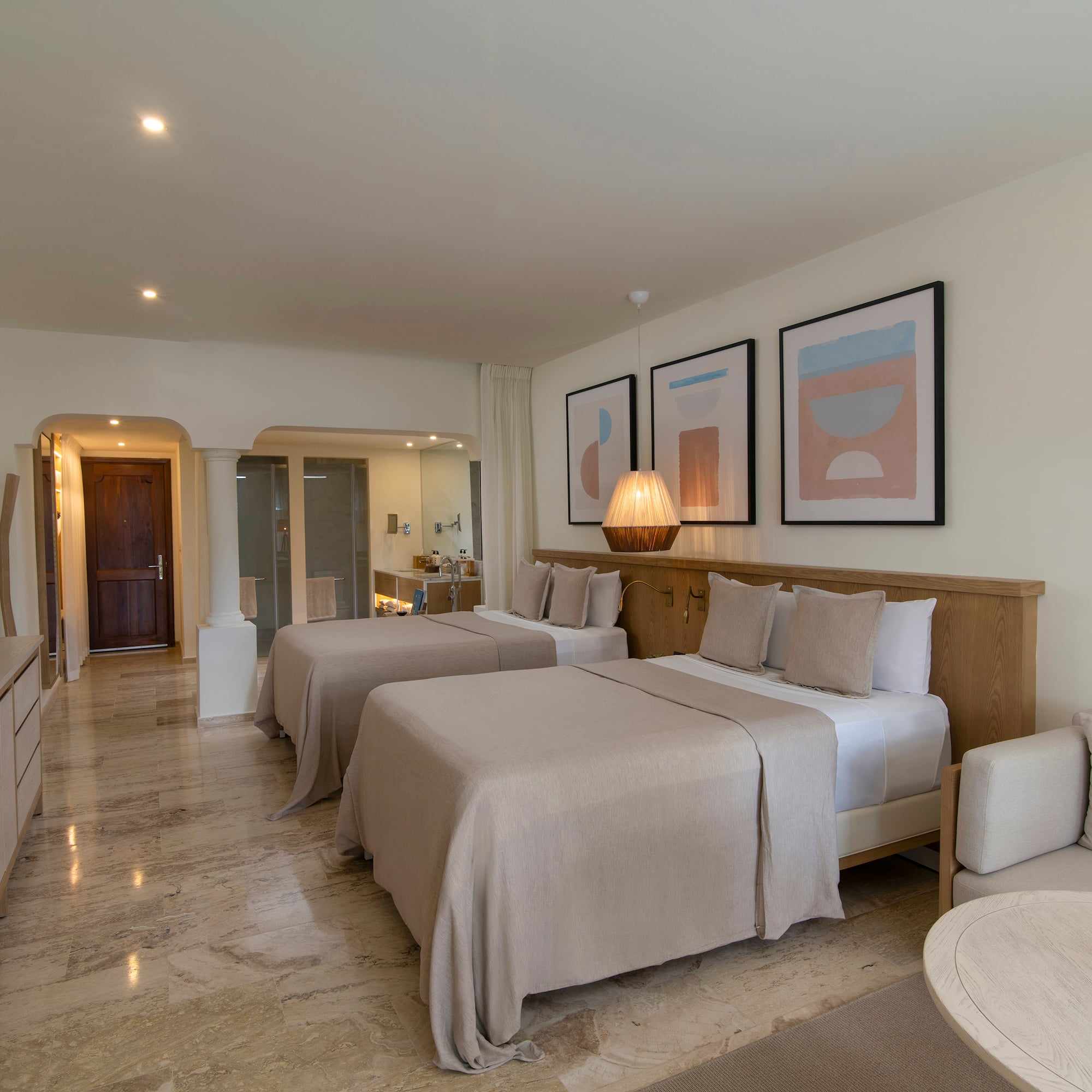 a room with two beds and a table