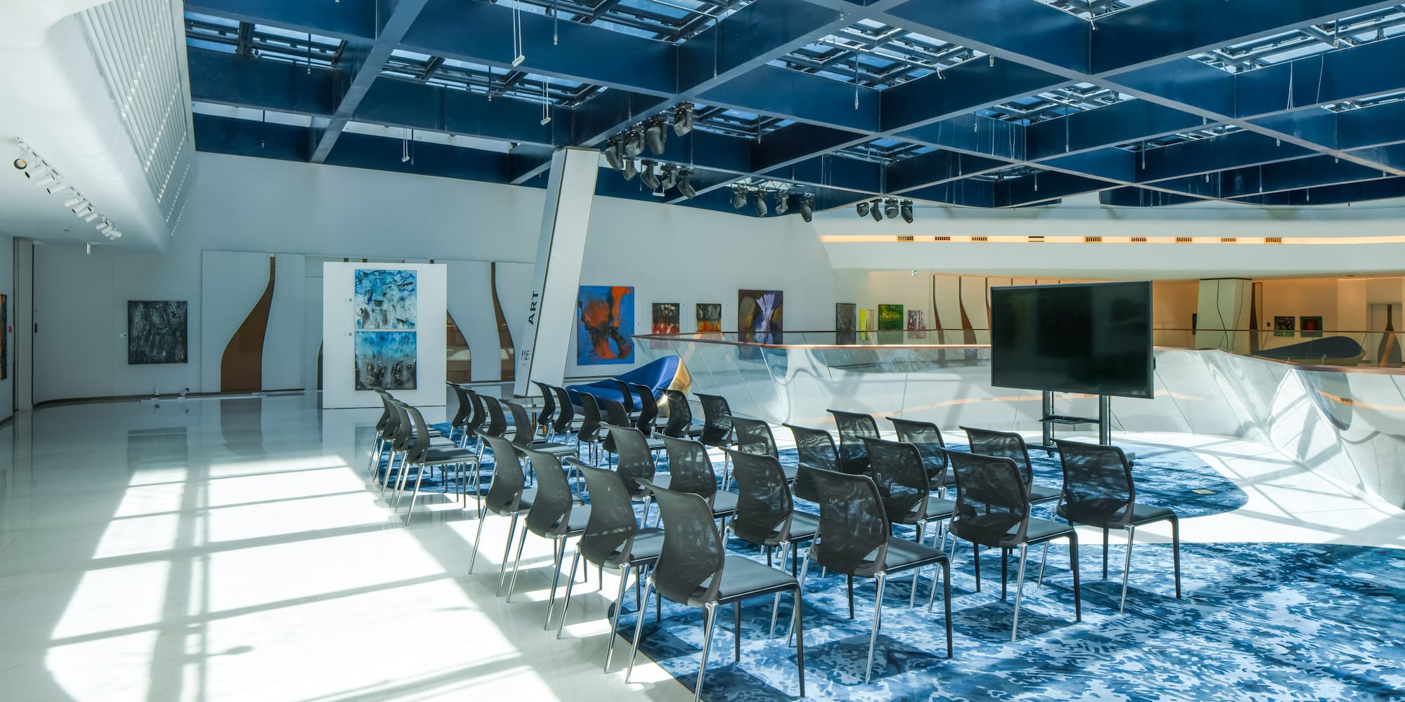 a room with many chairs and a television