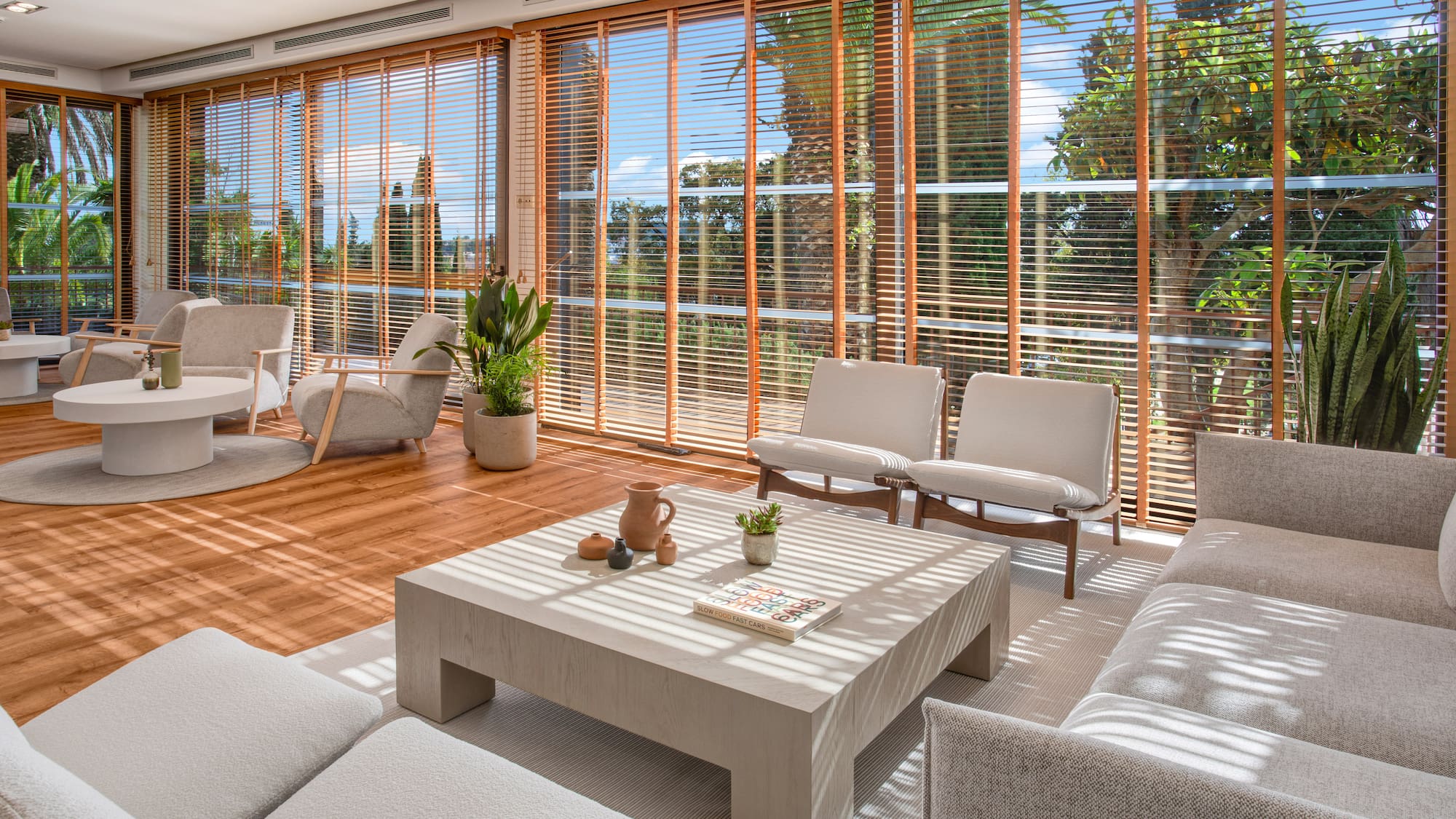 a room with a couch and chairs