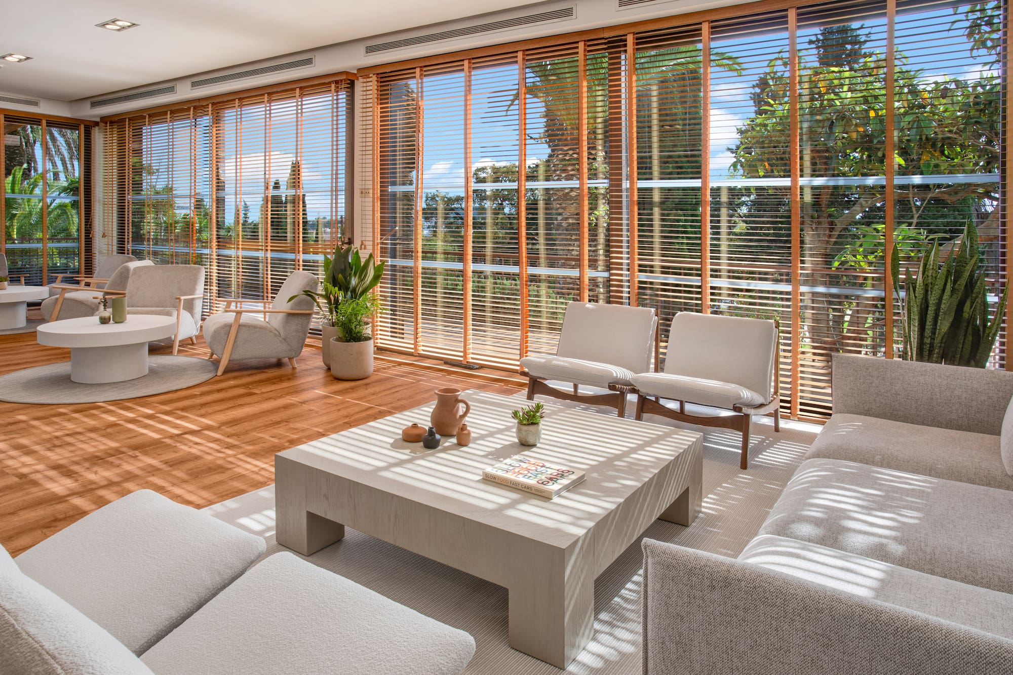 a room with a couch and chairs